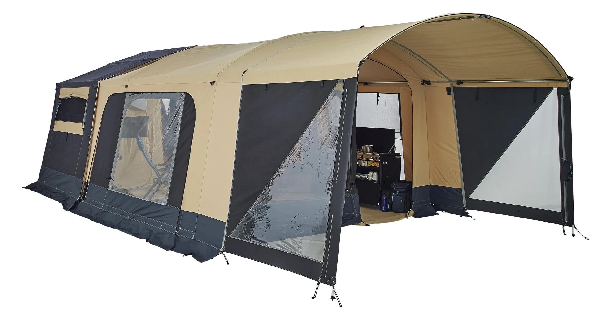 Large beige and black Trigano Galleon tent with multiple windows, partly open to reveal interior with kitchen setup and camping supplies.