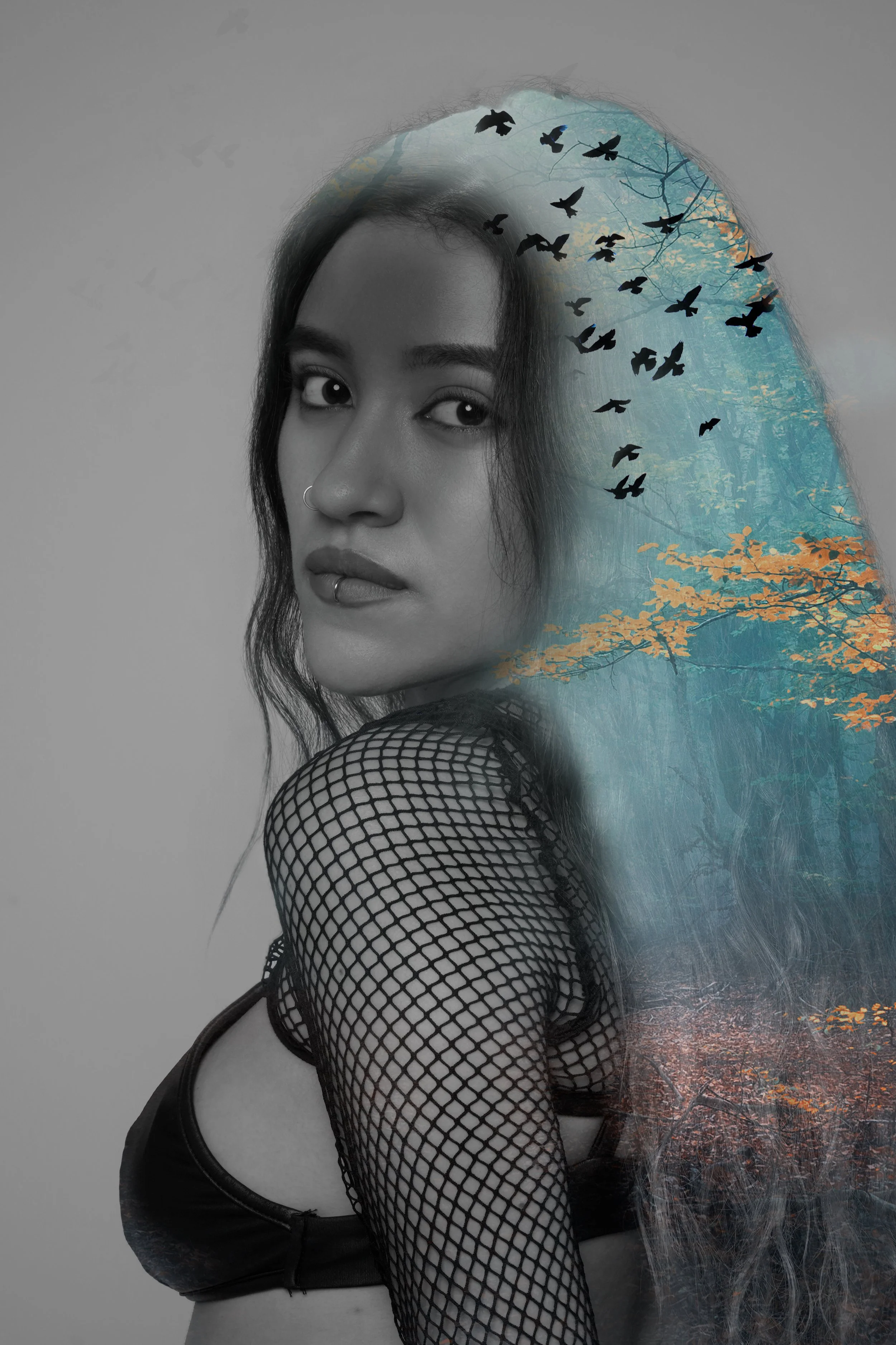 This image combines a black-and-white portrait with a colourful forest and flying birds. The contrast between the portrait and natural elements creates a sense of freedom, mystery, and connection with nature. The double exposure technique adds depth 