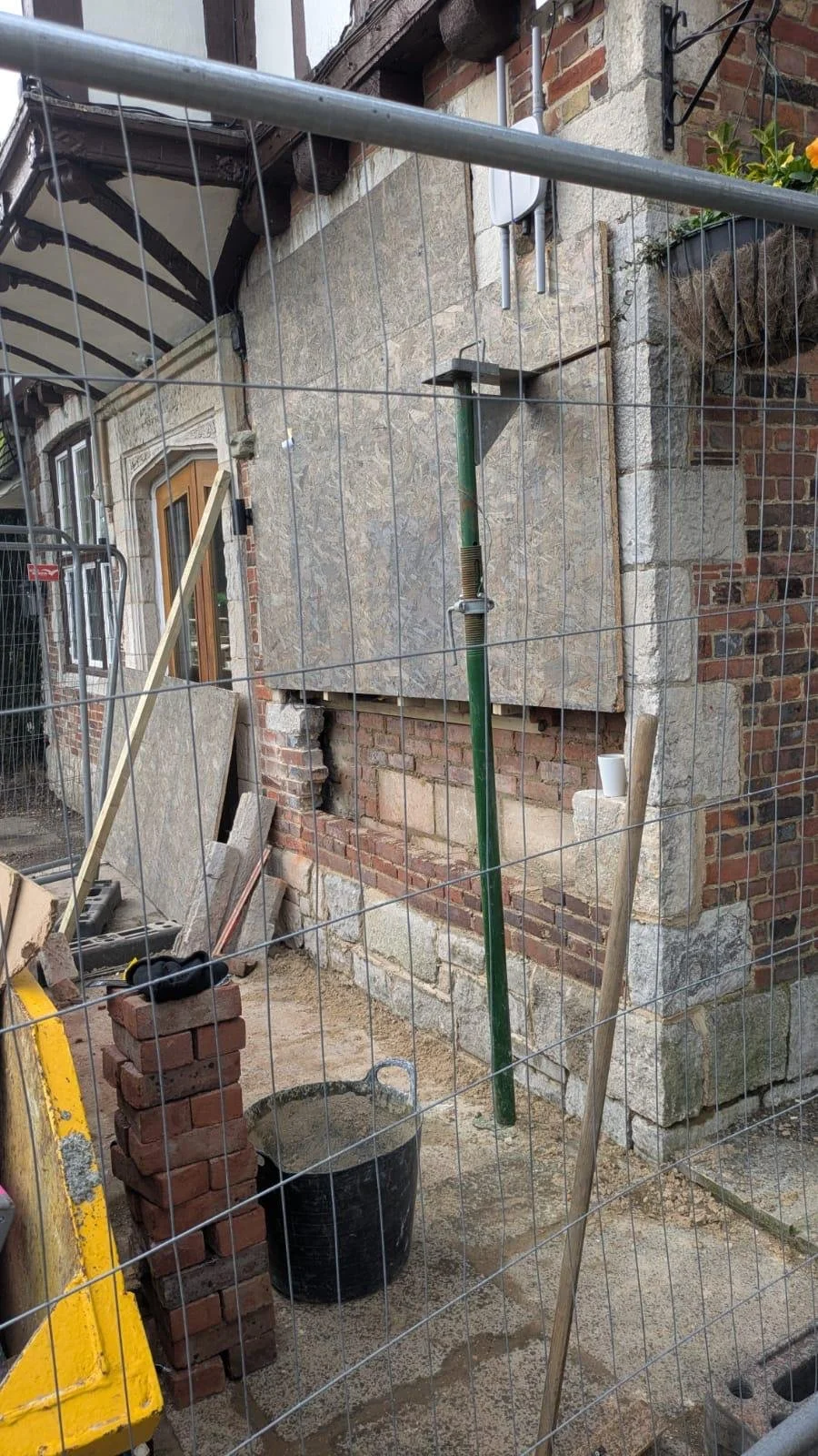 Pub in Polegate trading behind Heras fencing during structural repairs