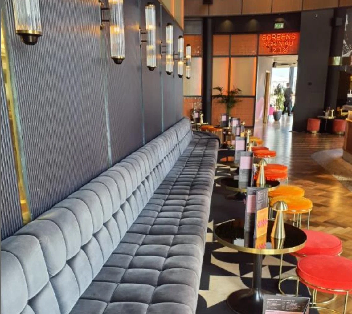 Everyman Cinema Bristol - showing the new lights installed by Medlec, a grey sofa, wooden flooring with tables and the new lights