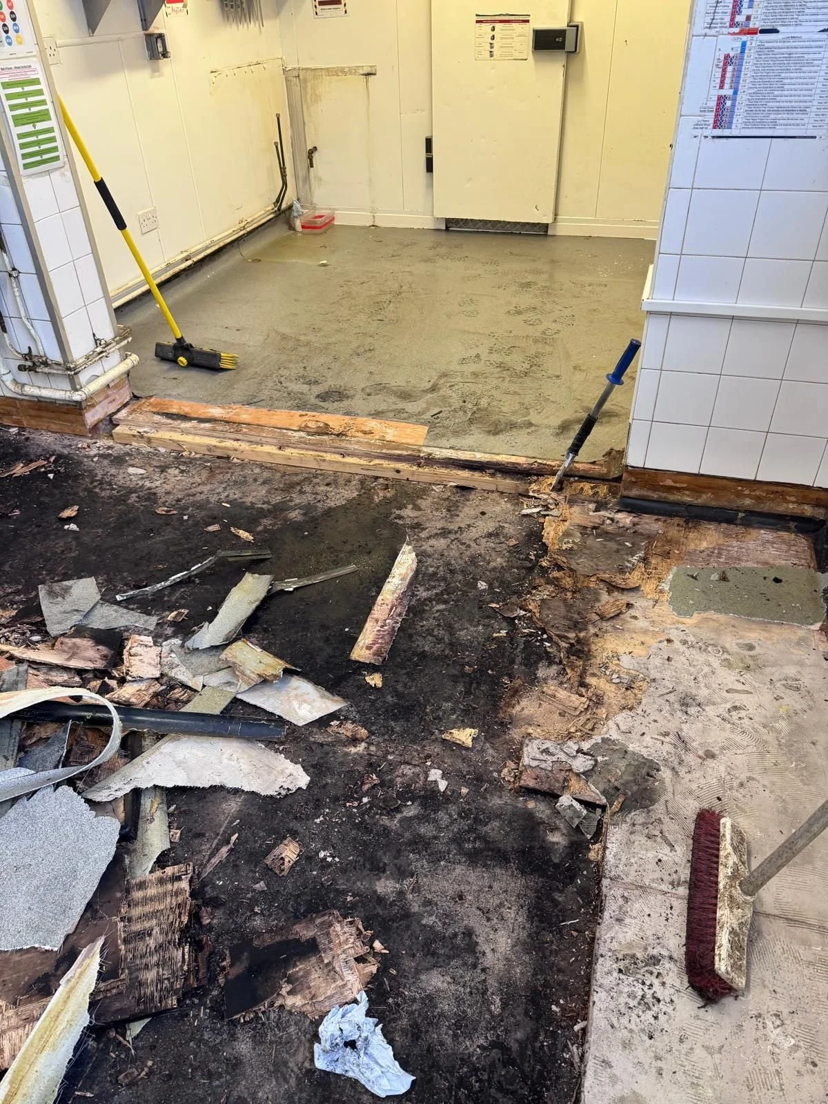 Image: Old flooring being removed at a  commercial kitchen 