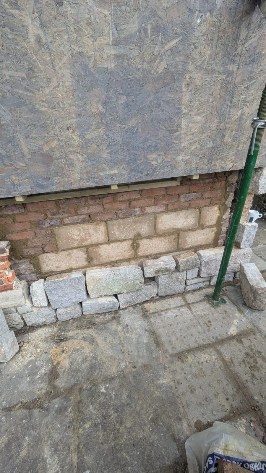External wall rebuilt with reclaimed stone and lime mortar in Polegate