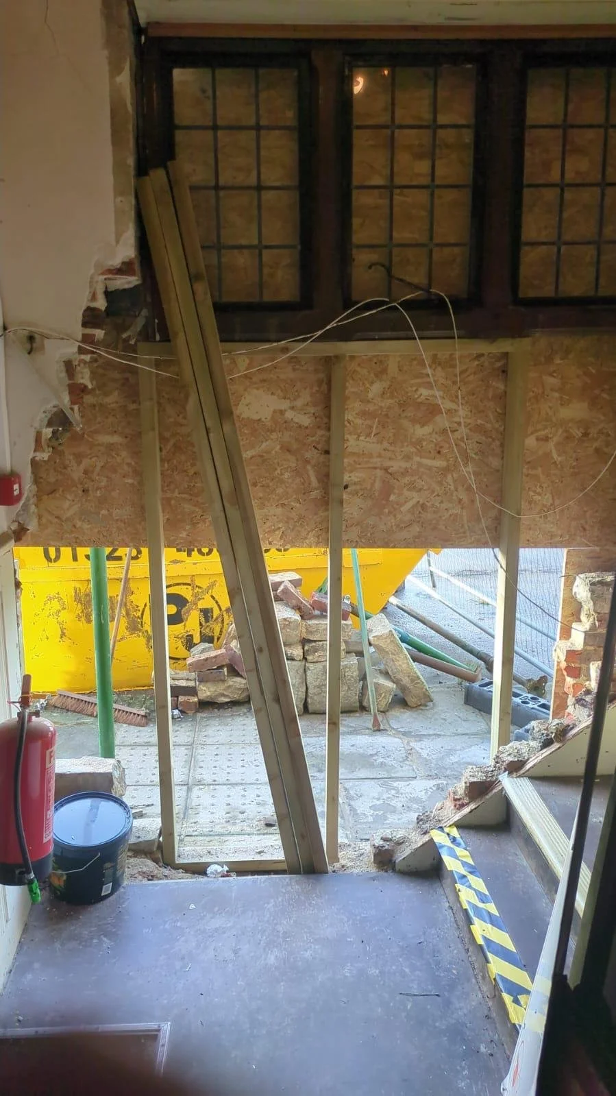 Opening propped and boarded inside a pub in Polegate after structural damage