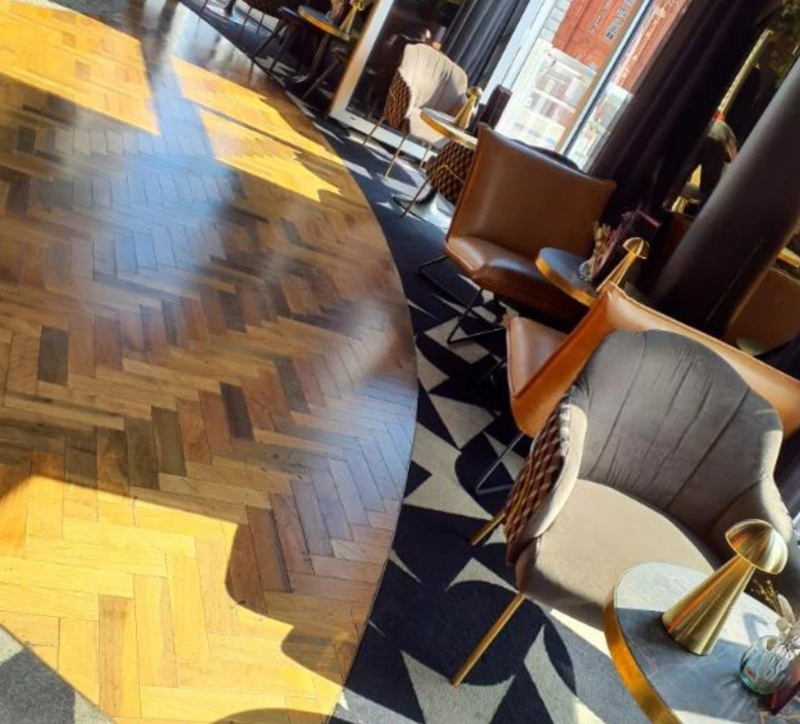 Everyman Cinema Bristol - showing the new lights installed by Medlec, a sofa, wooden flooring and orange and blue cusions with tables and the new lights
