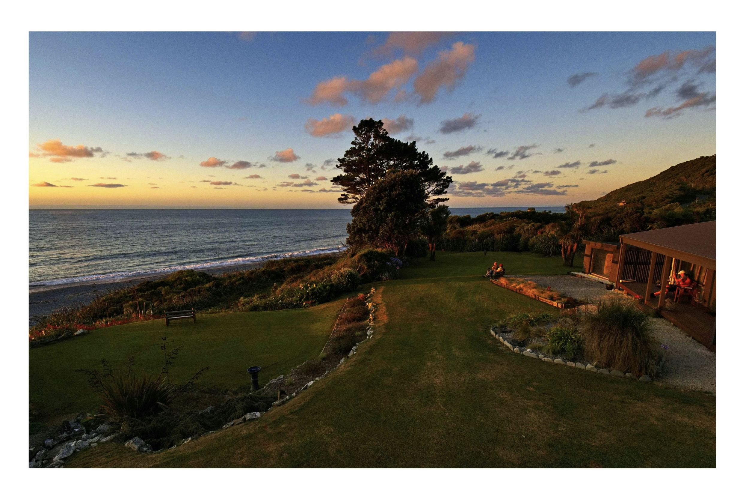 Guests enjoying watching teh setting sun over the Tasman Sea from Breakers Boutique Accommodation