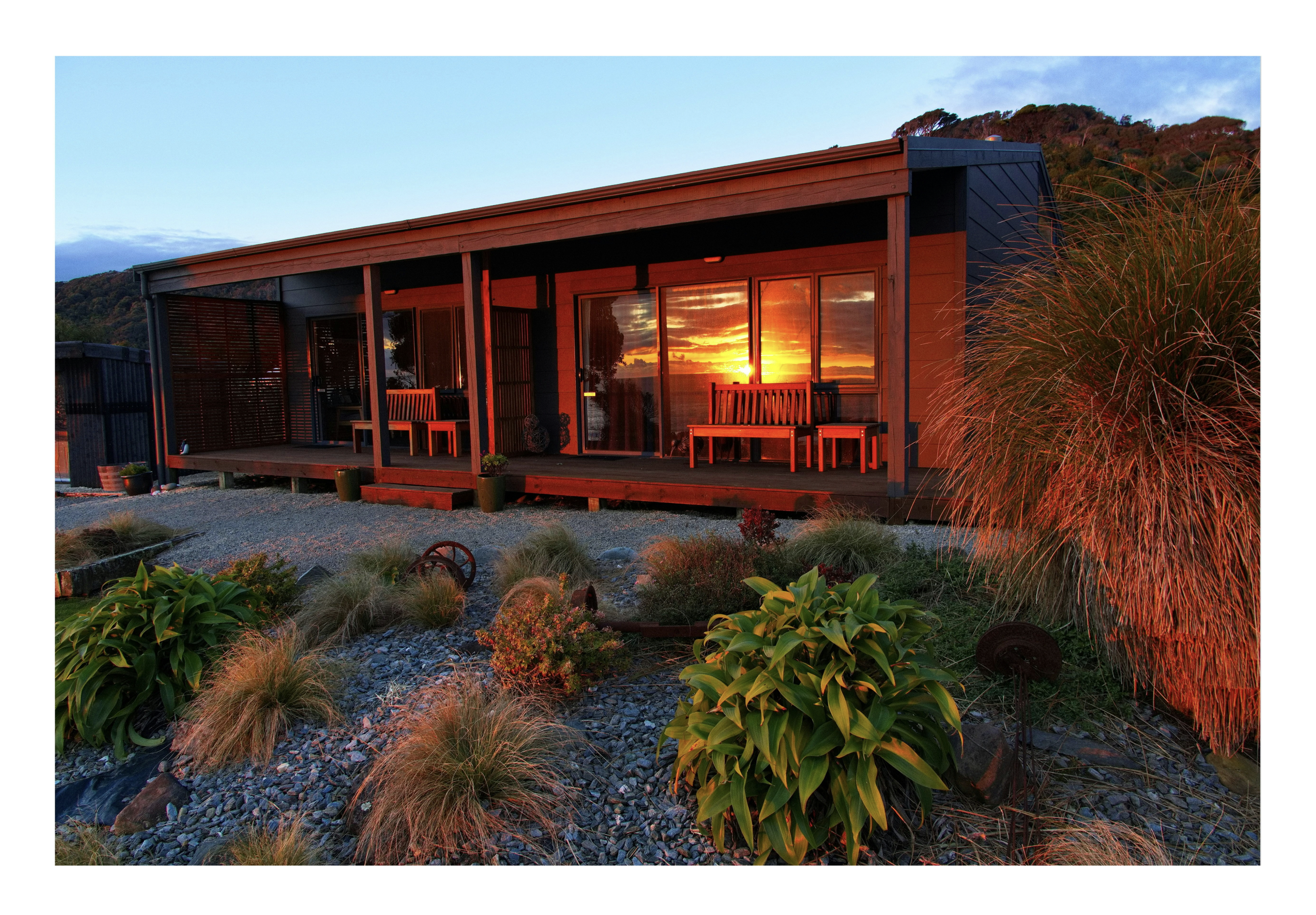 Sunset reflections in annex windows of Breakers Boutique Accommodation