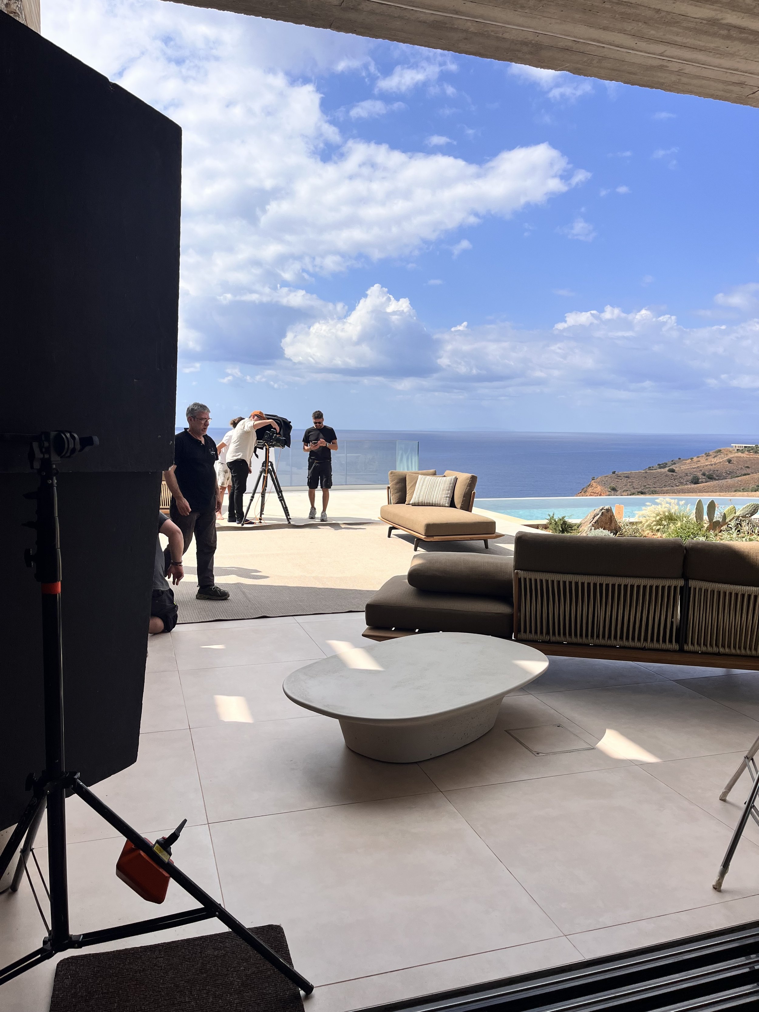 Professional film crew shooting on the terrace of Keras Cliff House, a luxury villa and commercial production location in South Crete, Greece