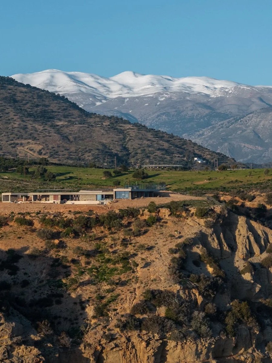 Clifftop villa Keras Cliff House with snow-capped Psiloritis in the background is a destination for winter holidays in Crete