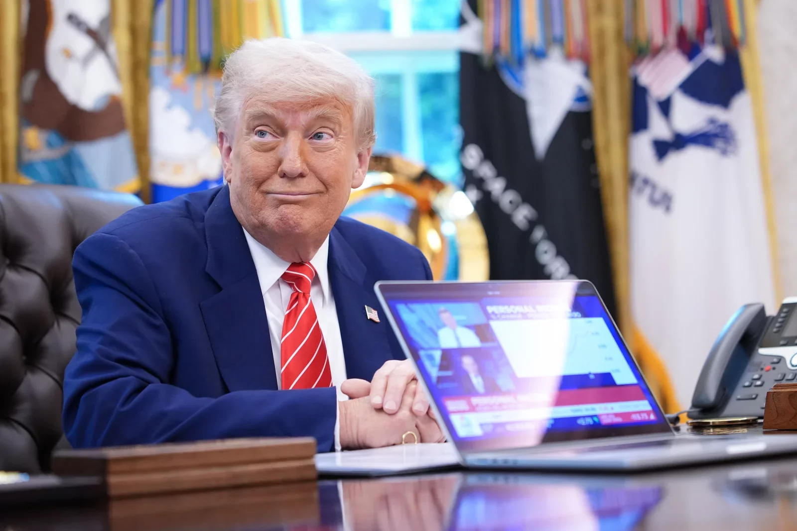 U.S. President Donald Trump, joined by Tesla CEO Elon Musk, shows a news video from a laptop in the Oval Office of the White House on May 30, 2025 in Washington, DC.  Kevin Dietsch/Getty Images North America