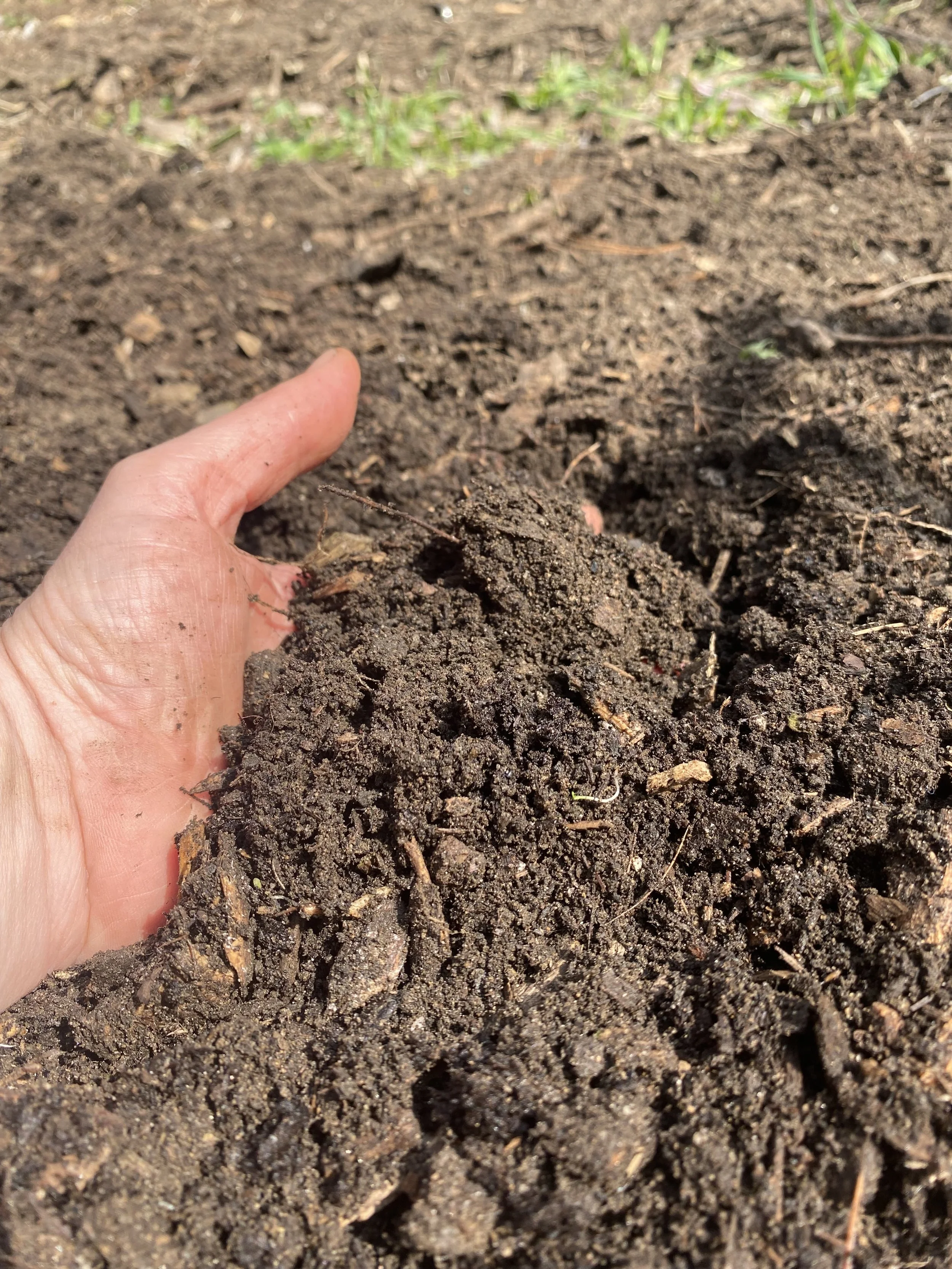 light skinned left hand flat and sliding brown dirt.