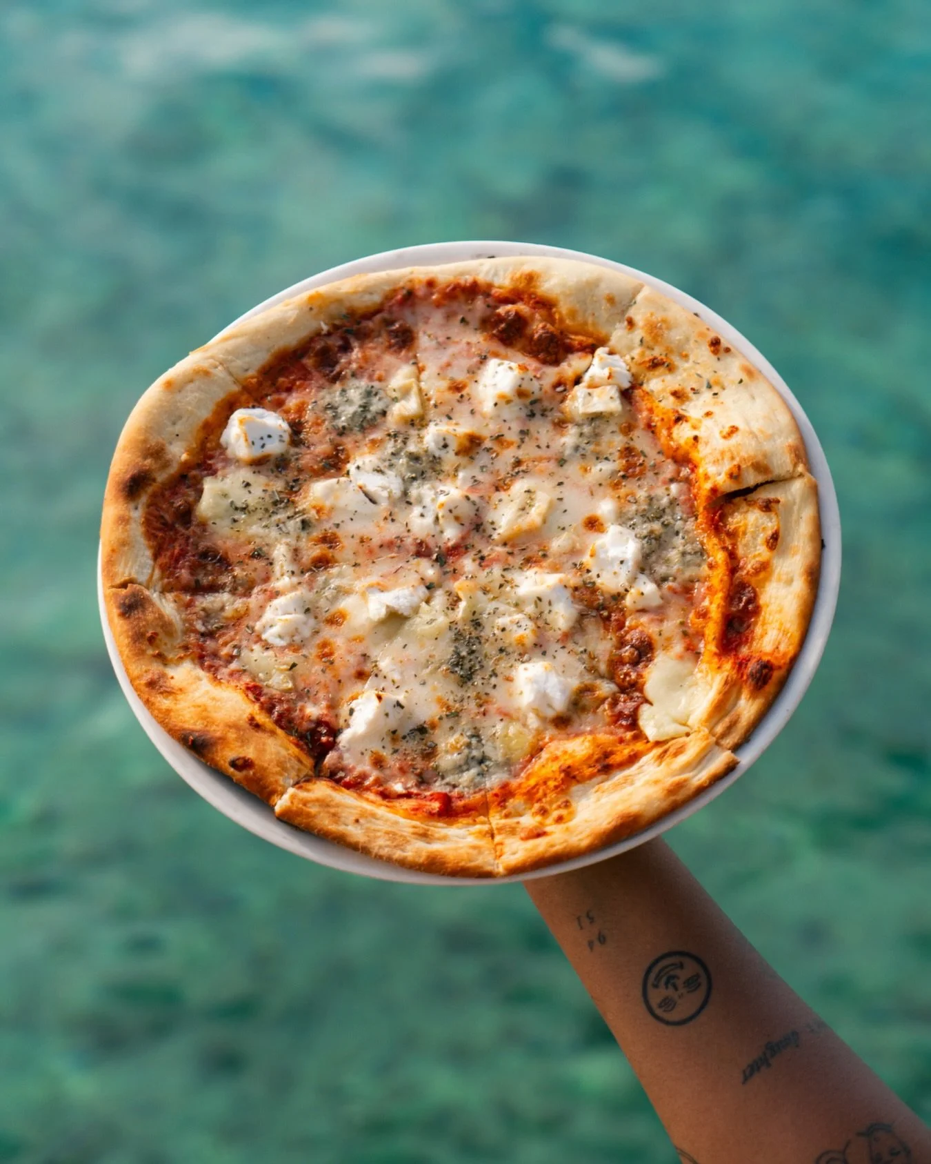 Crispy crust, melted cheese and that turquoise water in the background