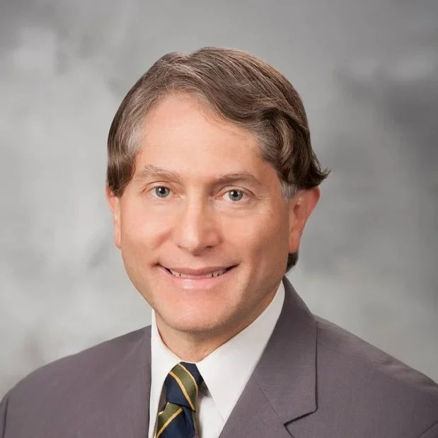 A professional headshot of Dr. Eduardo Kleer.