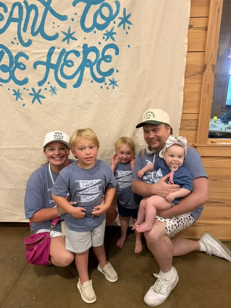 The Hauser family in front of the Hope Heals Camp welcome banner.