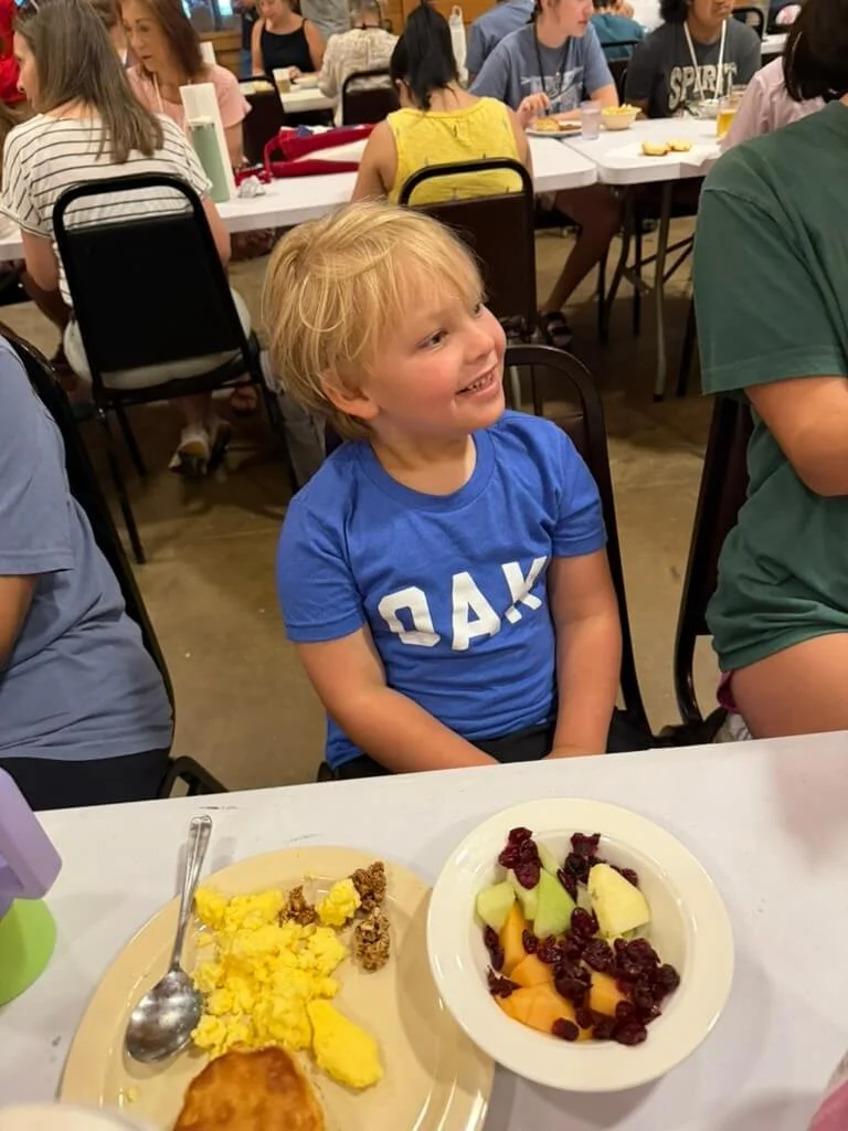 Amy Boland Hauser's son smiling at breakfast at Hope Heals Camp.