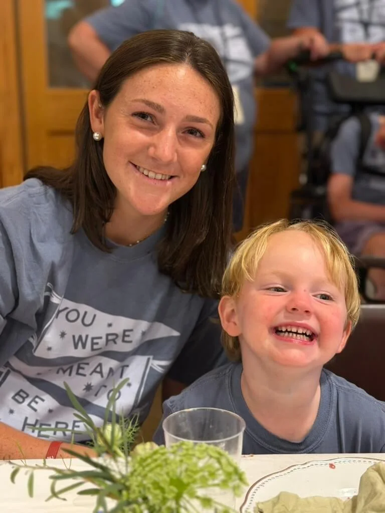  Woman smiling with boy at Hope Heals Camp. 