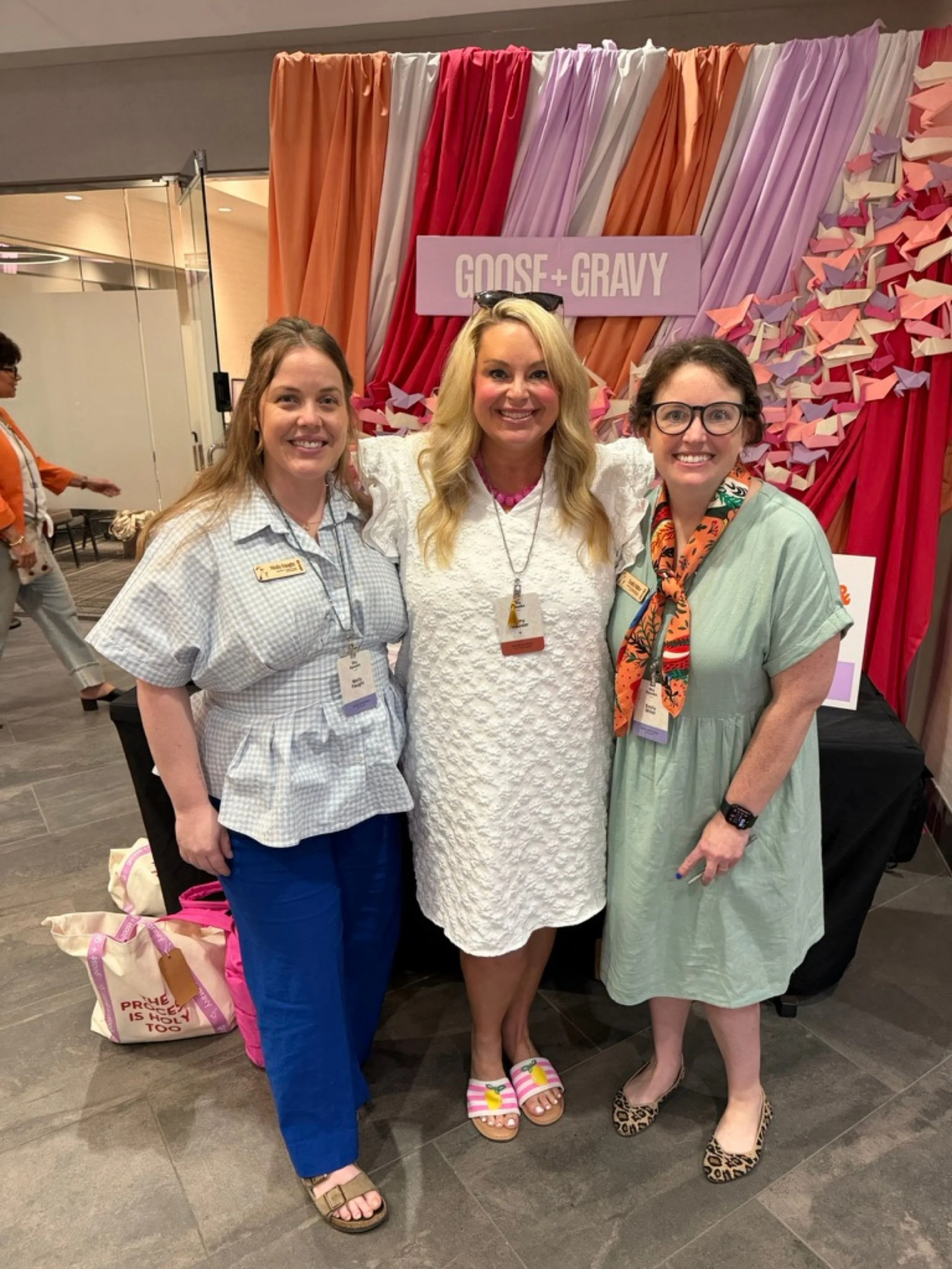 Amy Boland Hauser with two friends at the Goose and Gravy booth at She Speaks Conference.
