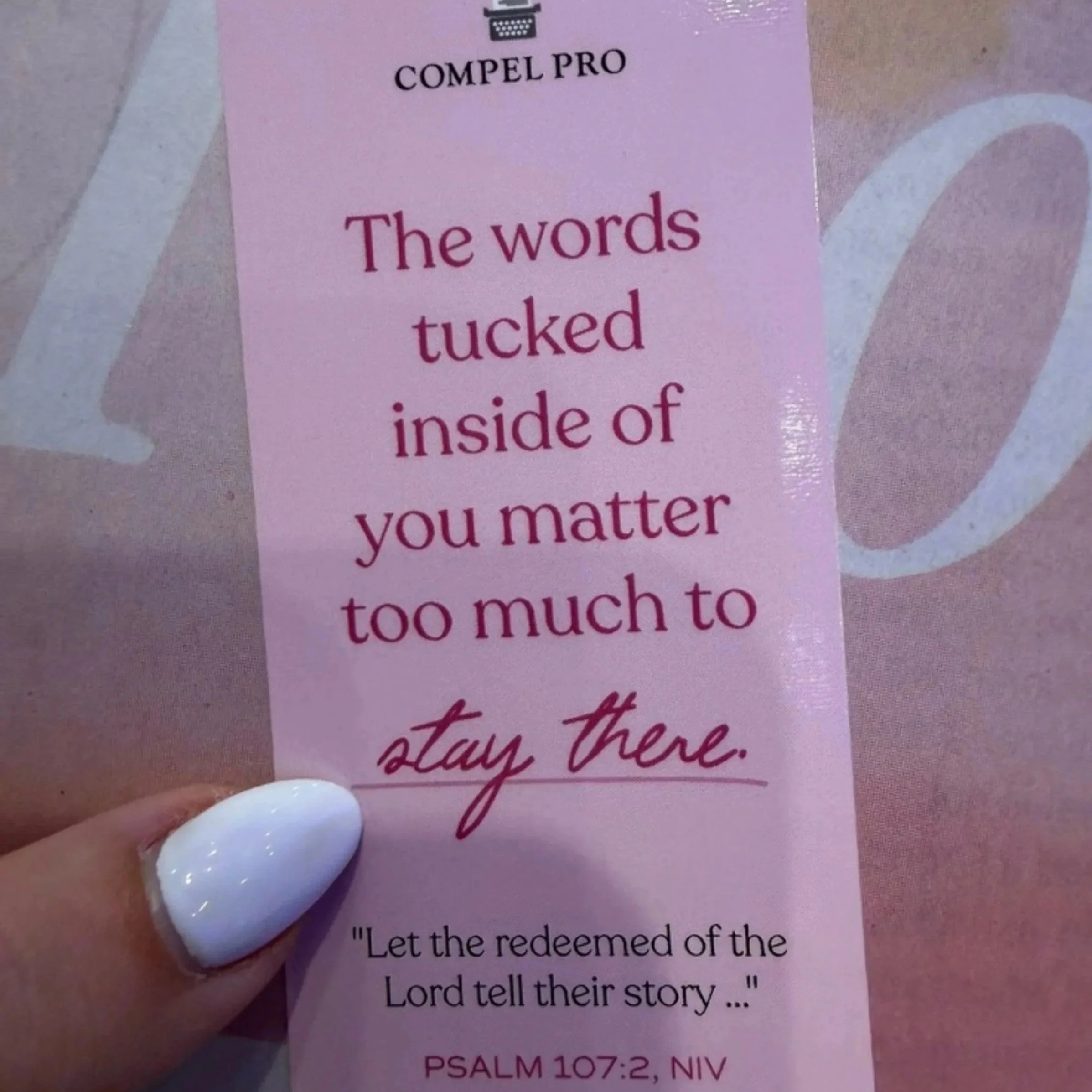 A Compel Pro bookmark with a Psalm 107 verse held at She Speaks Conference.