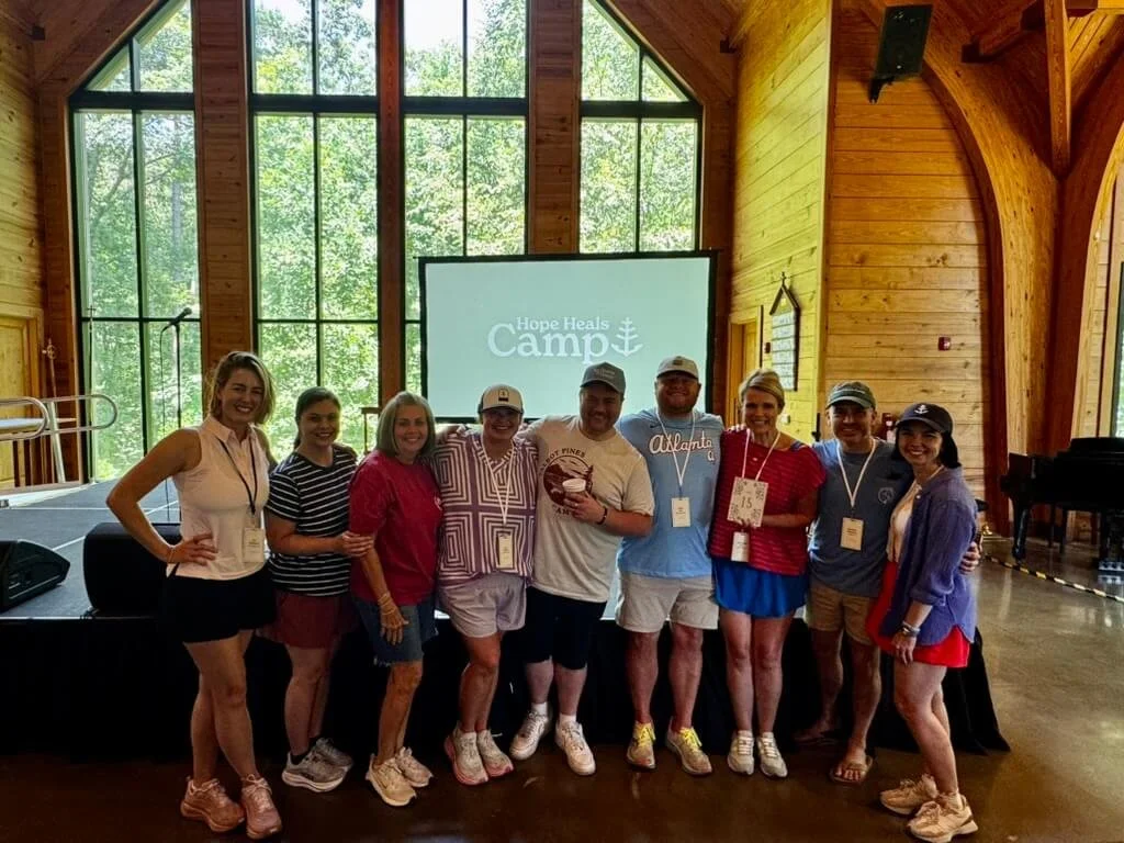 Camp friends smiling together inside the Hope Heals Camp chapel.