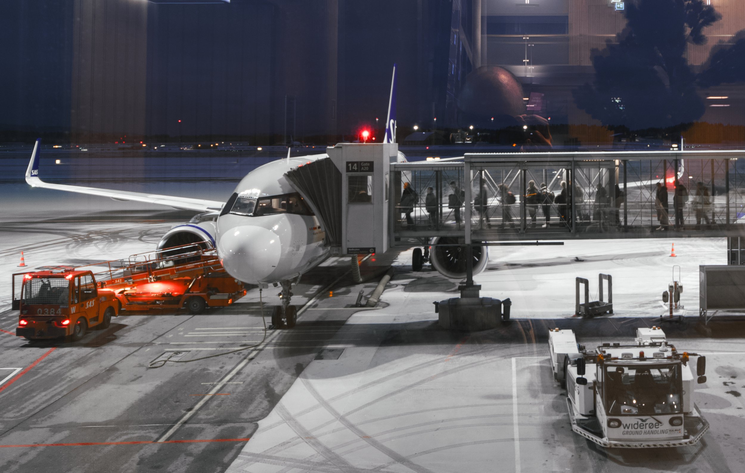 A SAS airplane is being boarded by a group of passengers at Gardermoen airport, Oslo, Norway. 