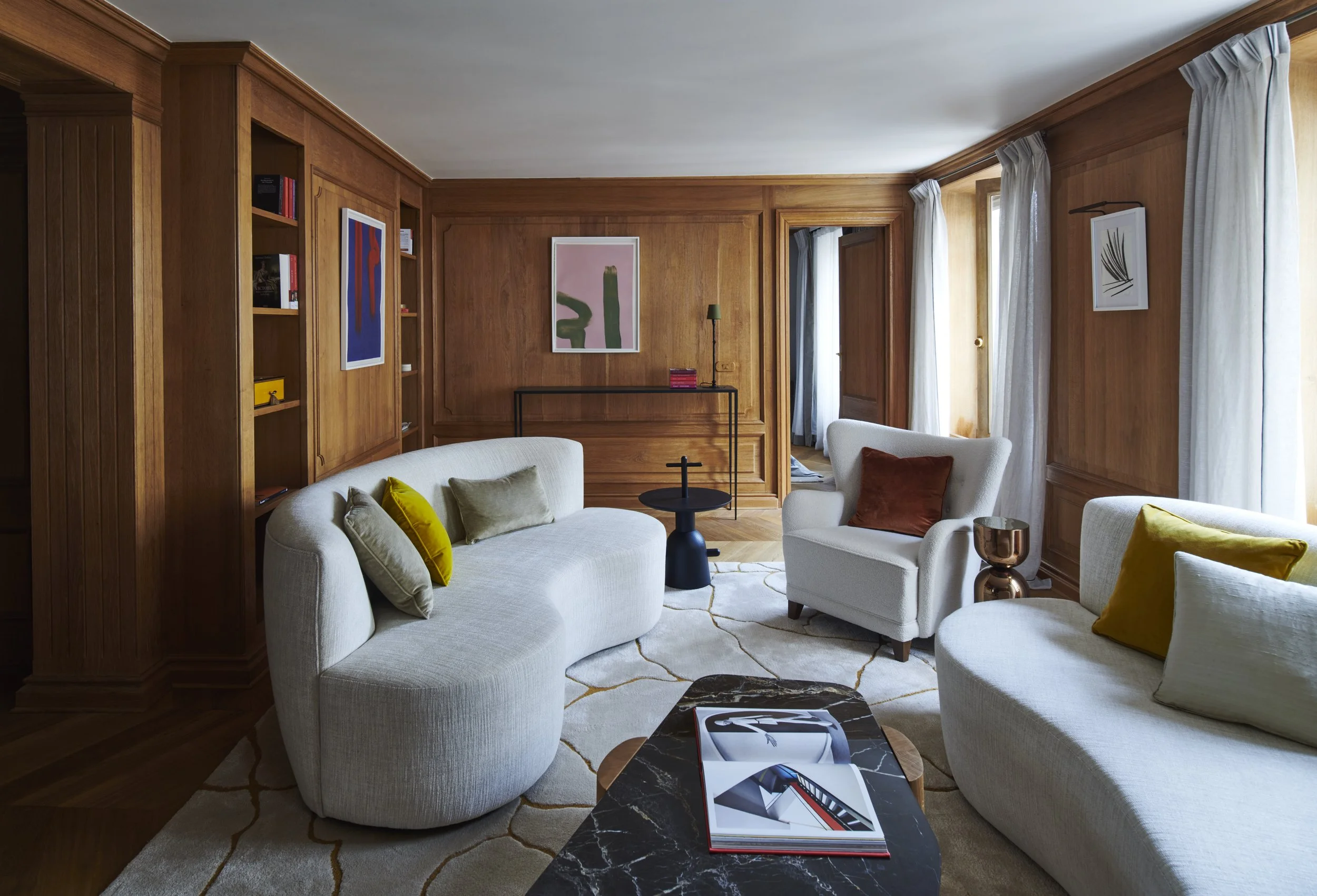 Interior image of an elegant Parisian apartment with reclaimed wood panelling, and contemporary furniture and art.