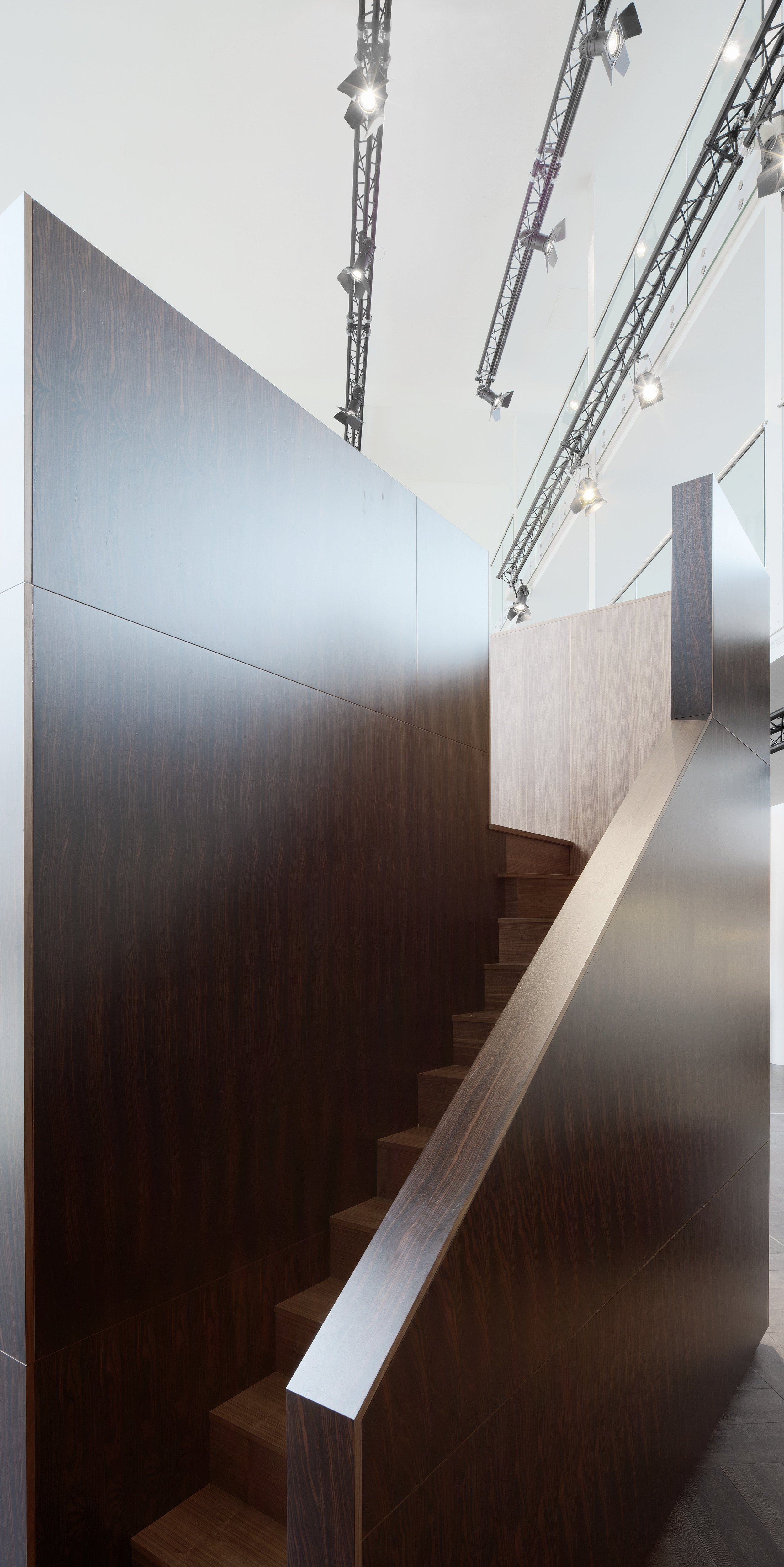 The stairs leading up the back of the timber lobby cube, with a view of the theatre lights above.