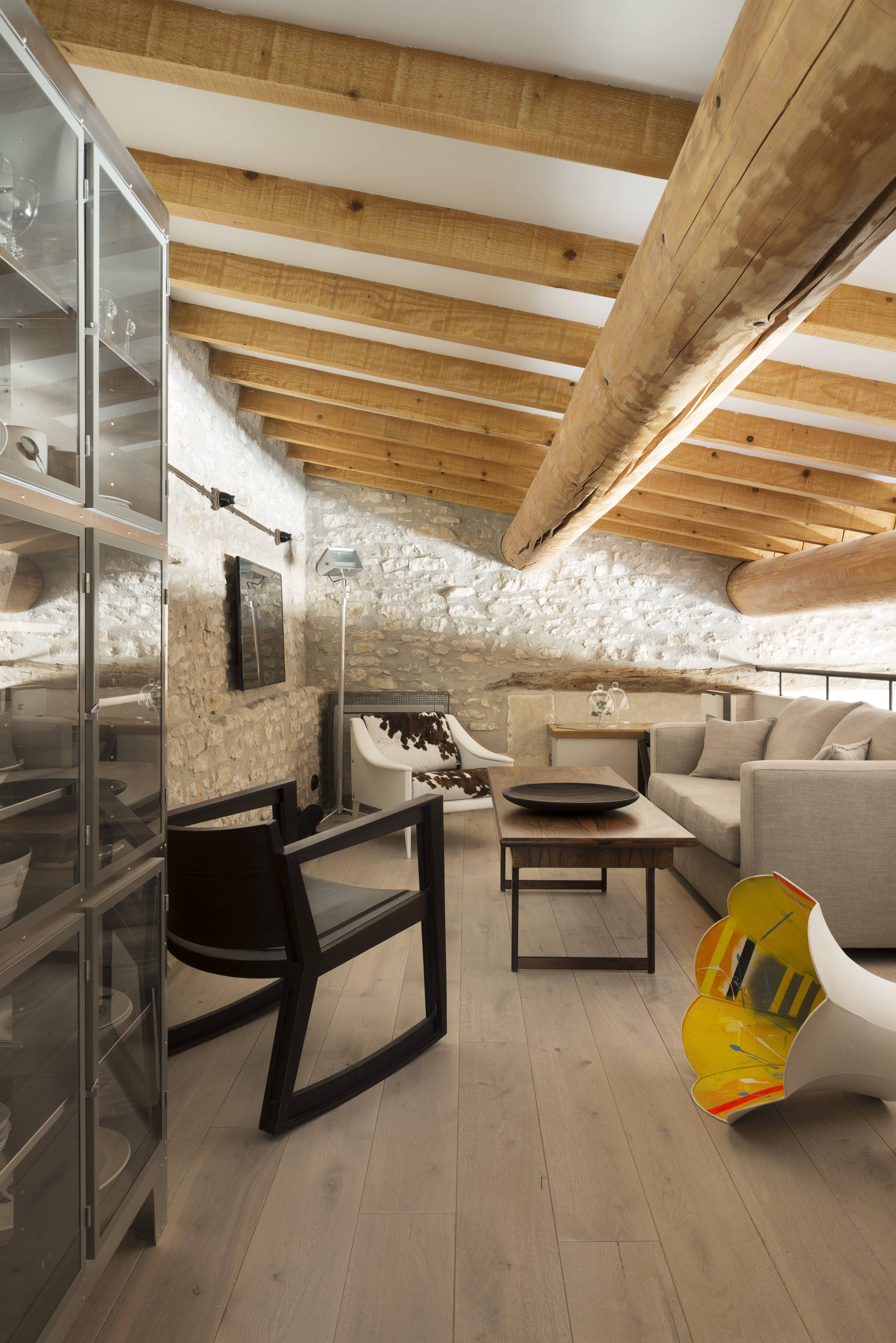 View of the first floor mezzanine sitting area with a mix of mid-century and contemporary furniture and lighting.