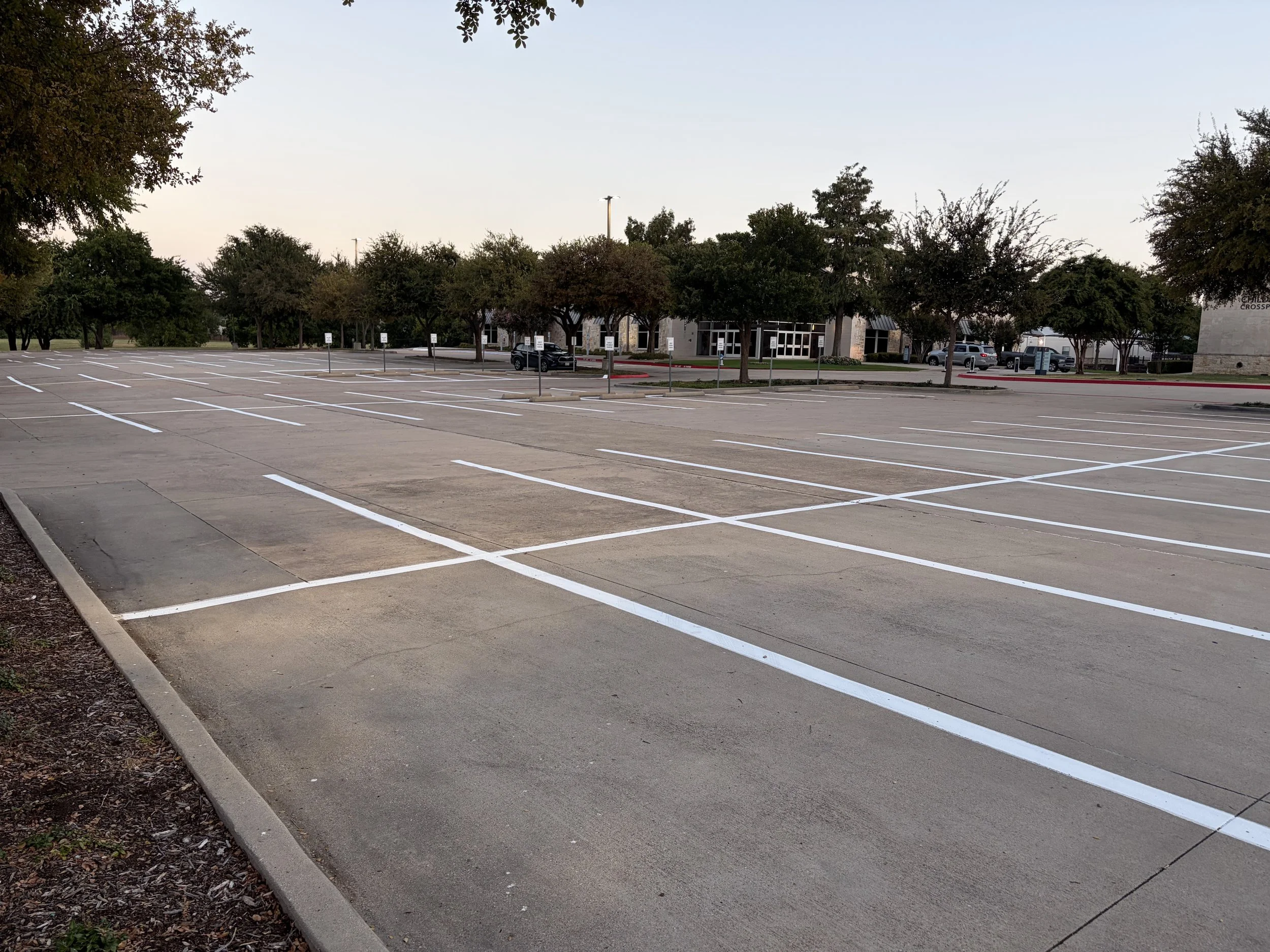 Fresh parking space lines after commercial lot restriping in DFW