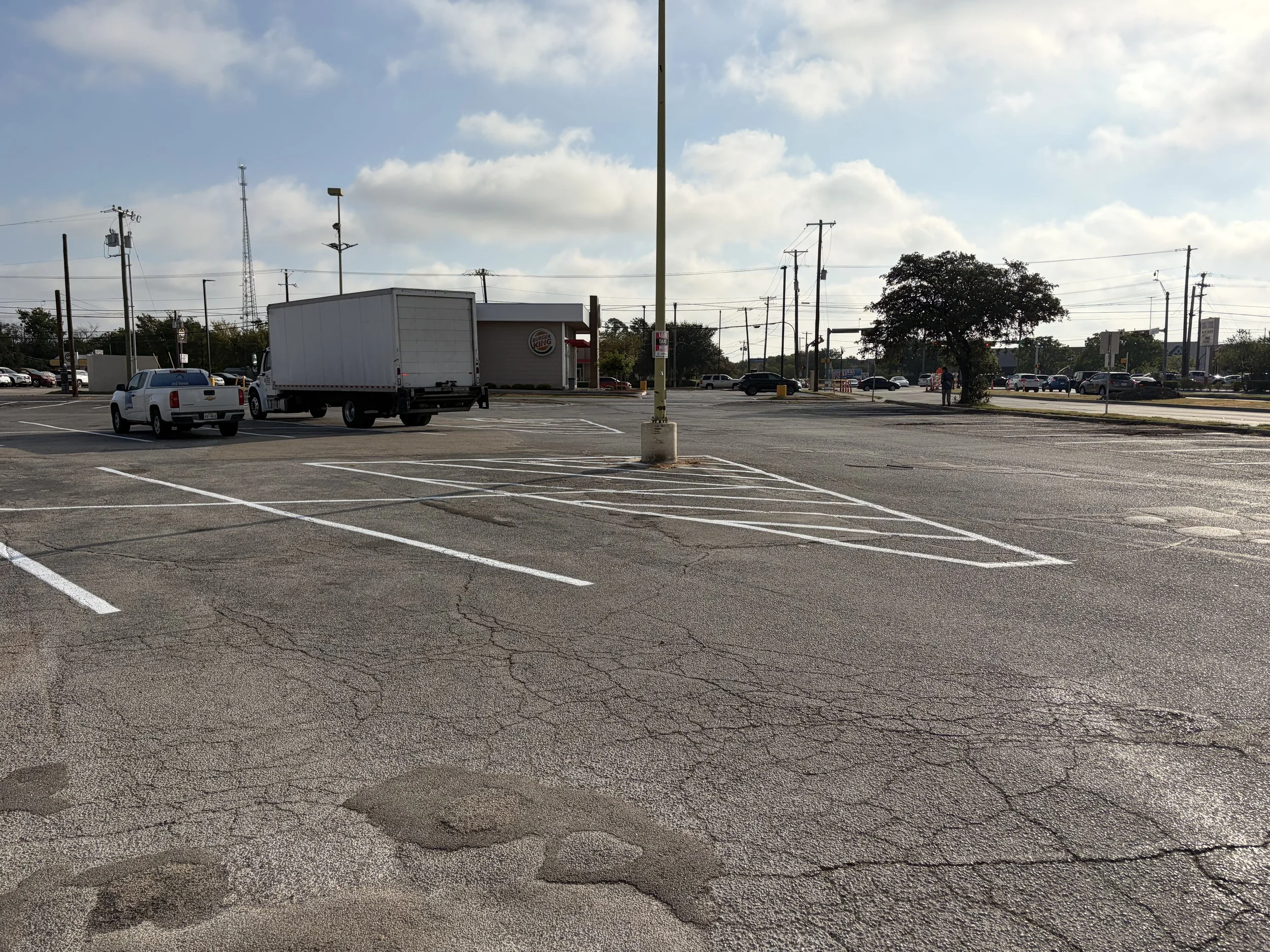 Commercial parking lot restriping in Garland, Texas.