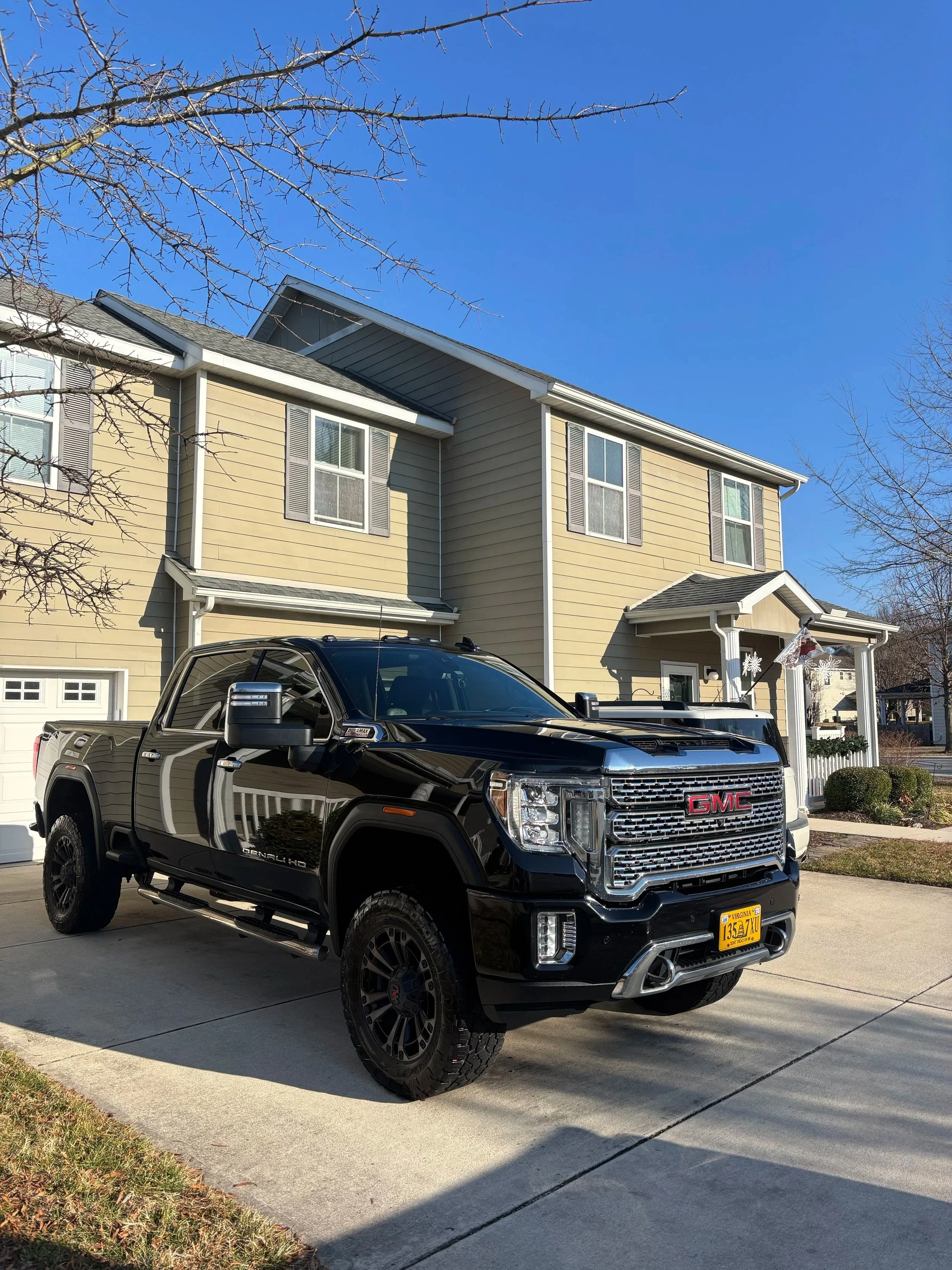 GMC Sierra Denali paint restoration showing deep gloss after clay decontamination and wax protection