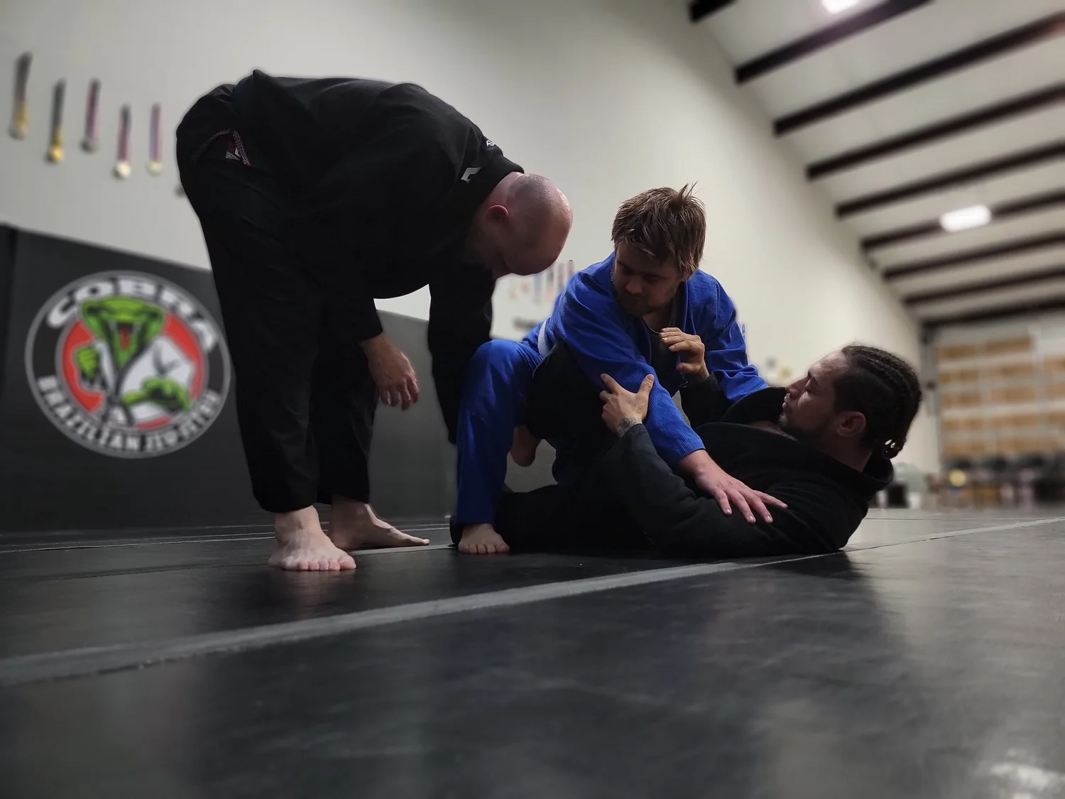 Two pairs of adult students rolling during class