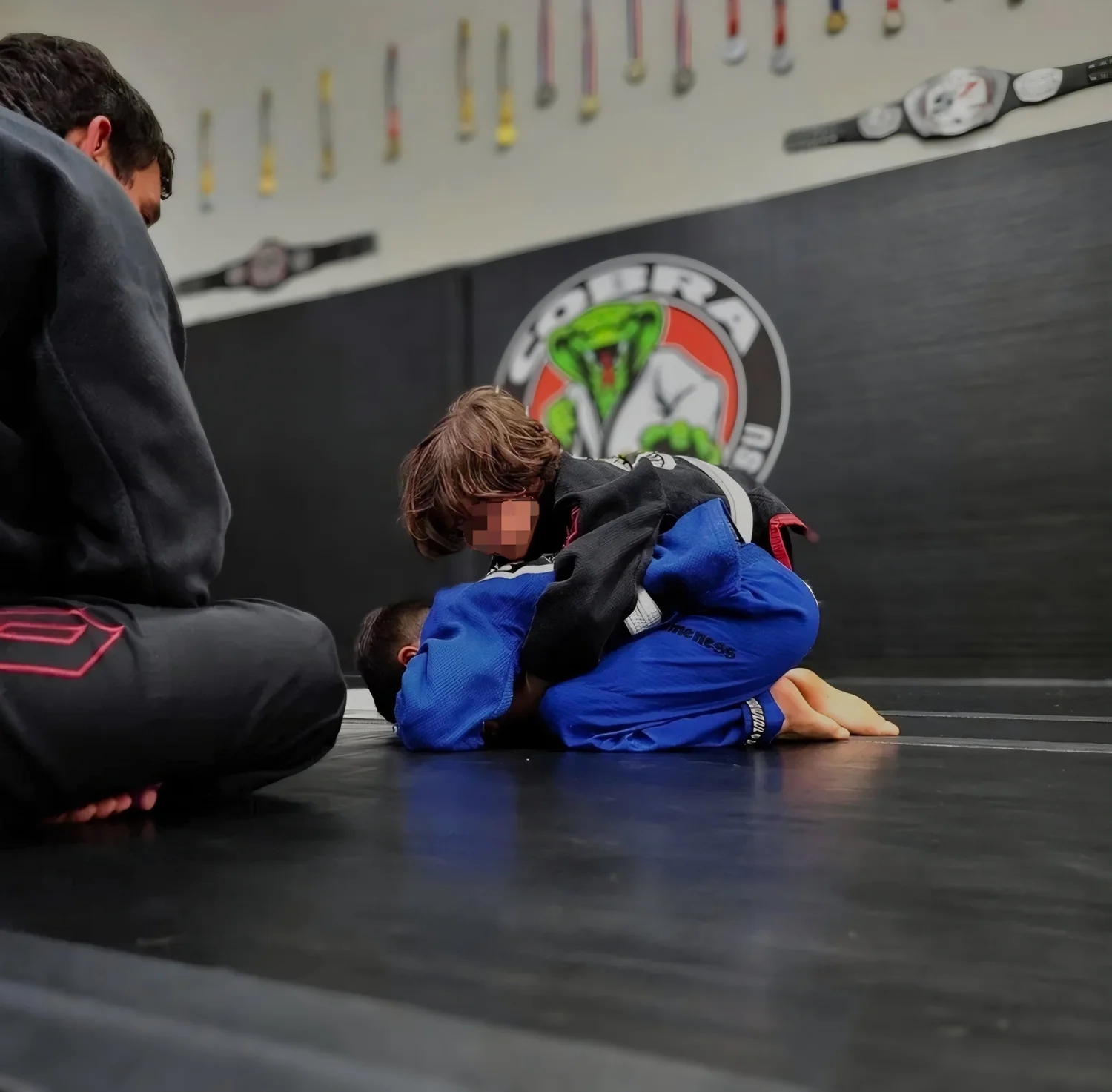 A young student working from mount during the kids class at Cobra BJJ Mansfield