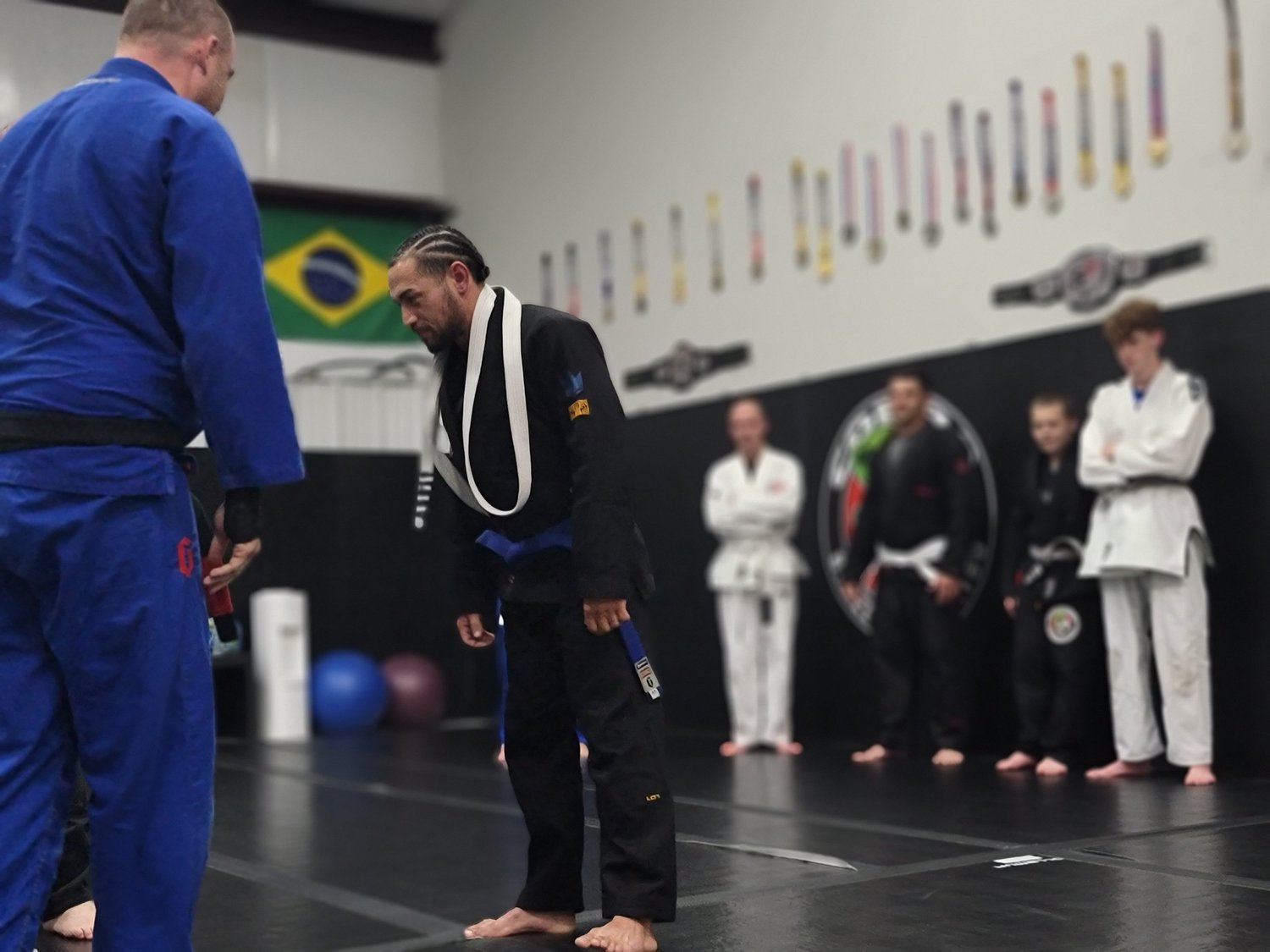 Students lined up in gis at the end of class at Cobra BJJ