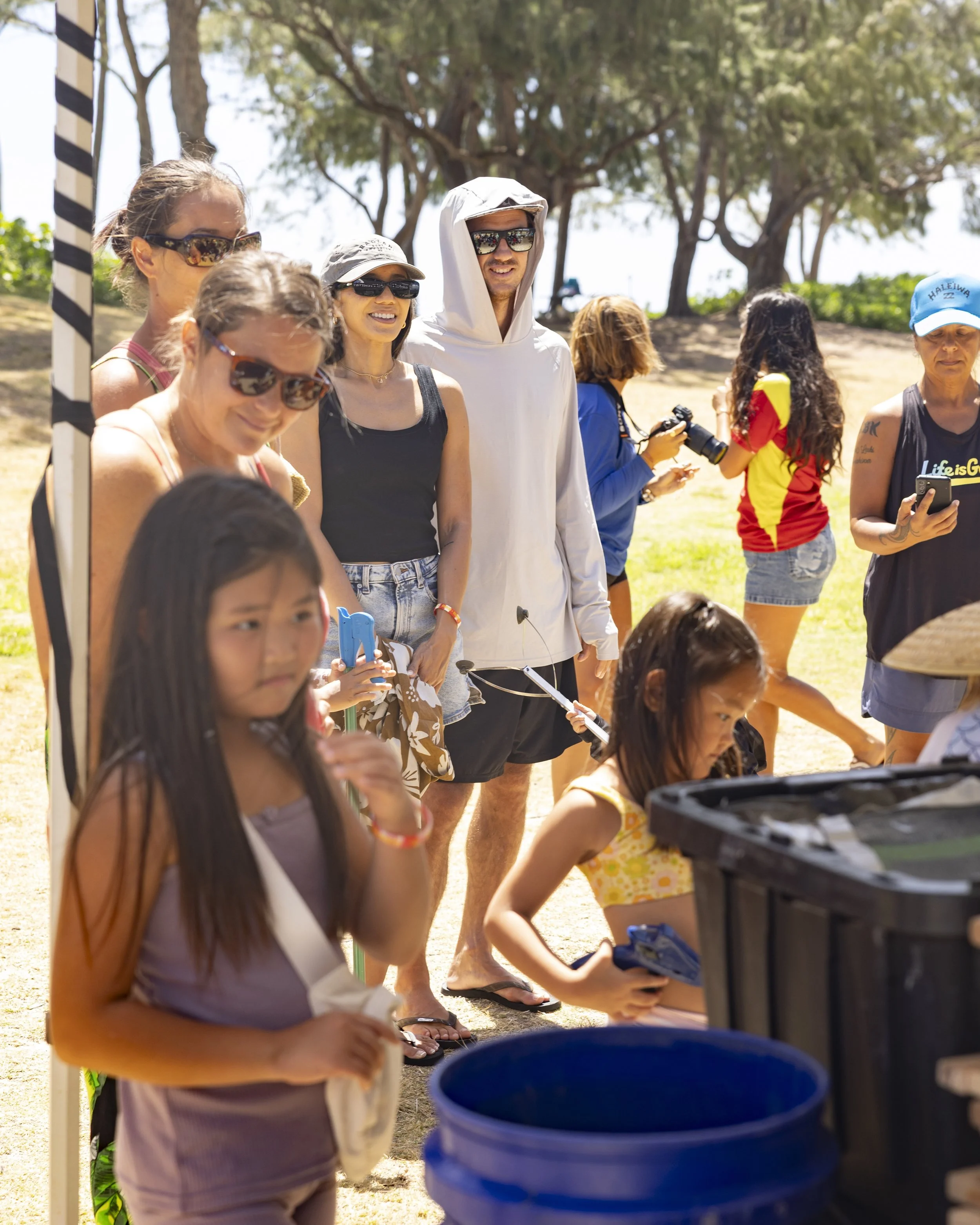 beach clean up participants with equipment in kailua, oahu