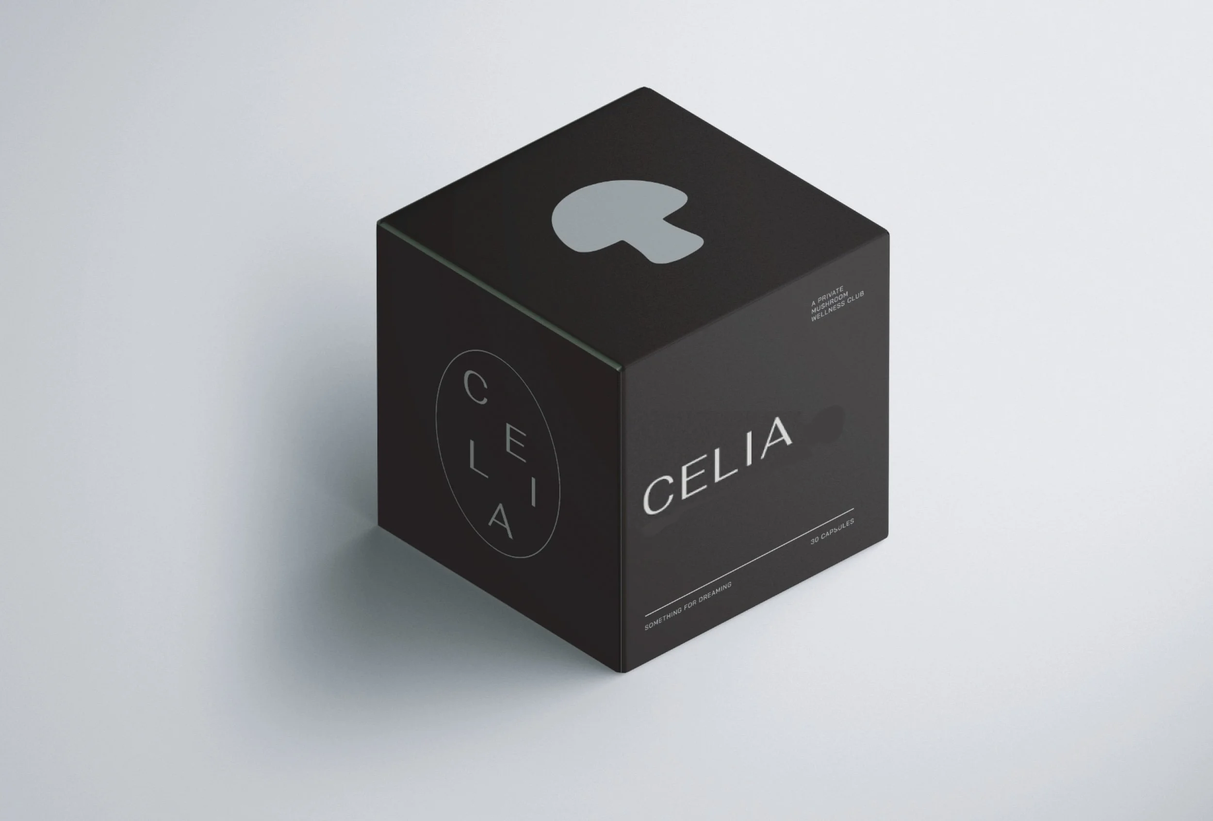 Black cube-shaped box with minimalist design, labeled 'CELIA' and '30 capsules', with text indicating it's a private wellness club product, placed on a white surface.