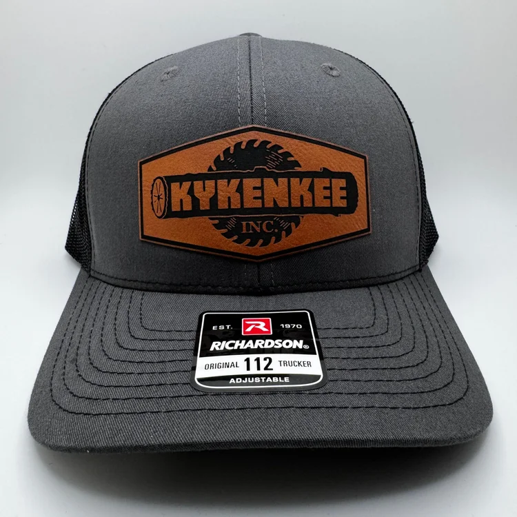 Richardson 112 charcoal and black trucker cap with Kykenkee rawhide logo patch