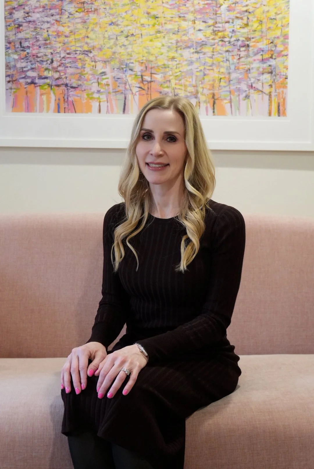 Jennifer seated in office sofa