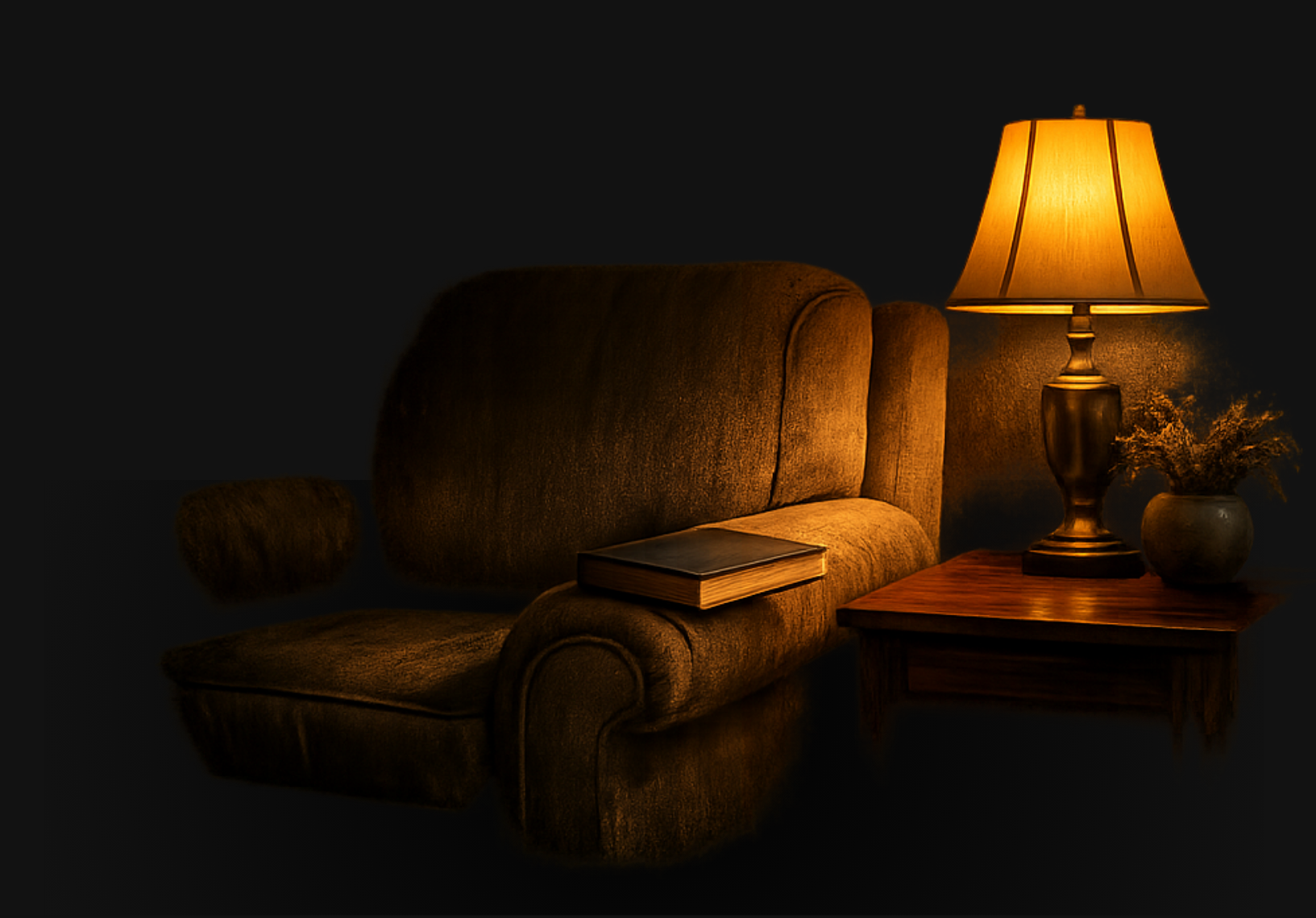 A cozy living room corner with a vintage brown sofa, a closed book on the armrest, a wooden side table with a lit traditional table lamp, a small vase with dried flowers, all illuminated by warm light against a dark background.