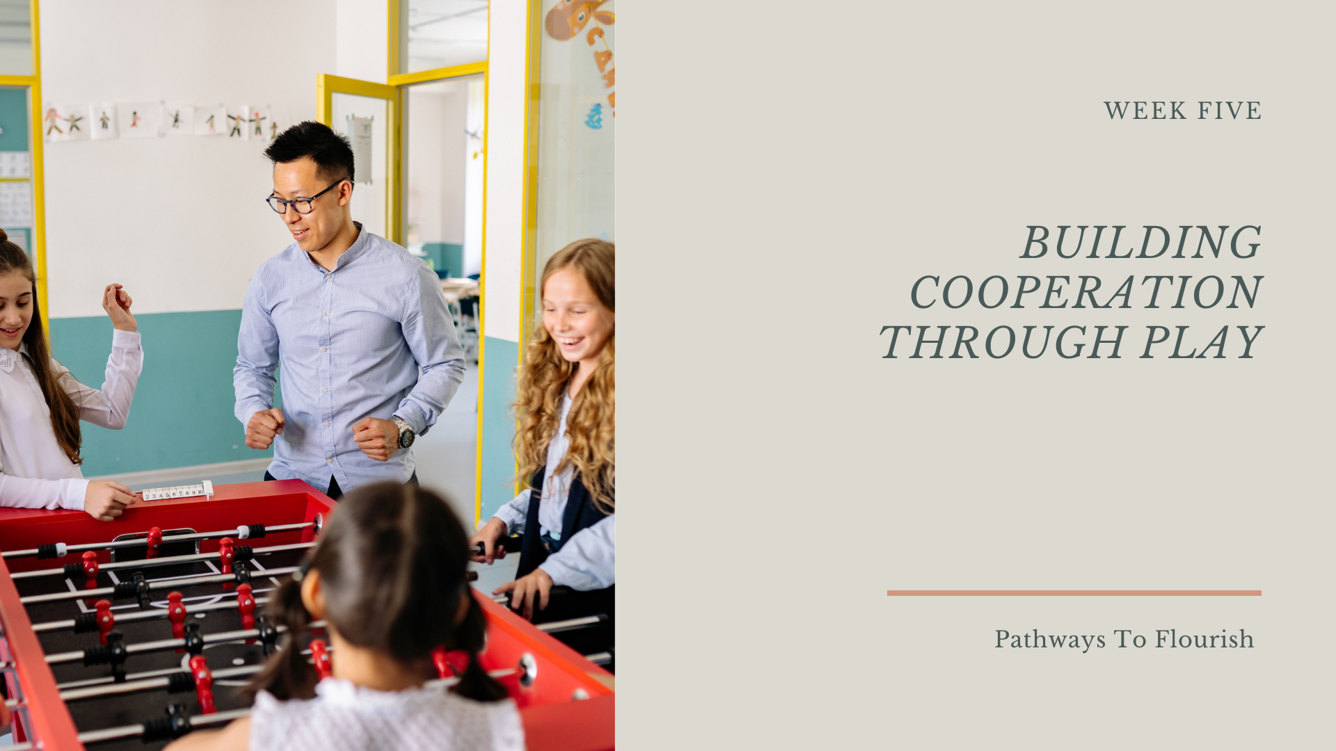 Children and a teacher playing foosball in a classroom, engaging in a cooperative activity.