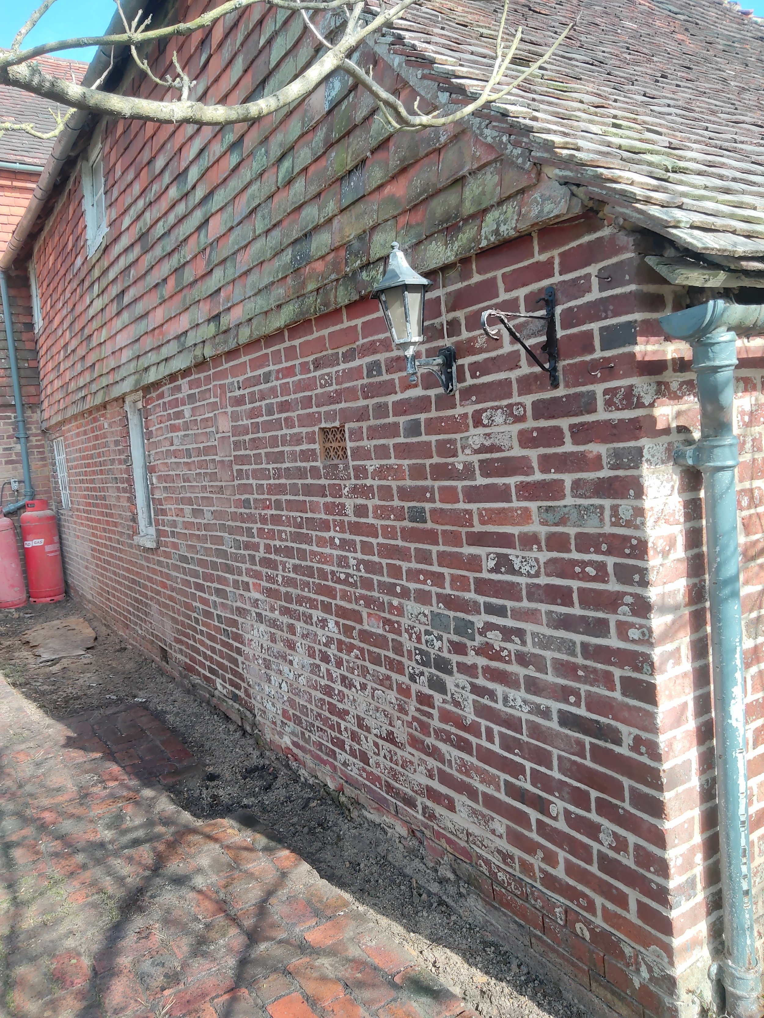 A Grade II listed cottage experiencing damp and algea. We removed the problem cement and replicated the rather hard Lime mix this victorian extension (on a much older building) was built with. This is part of a bigger project that involves the remov