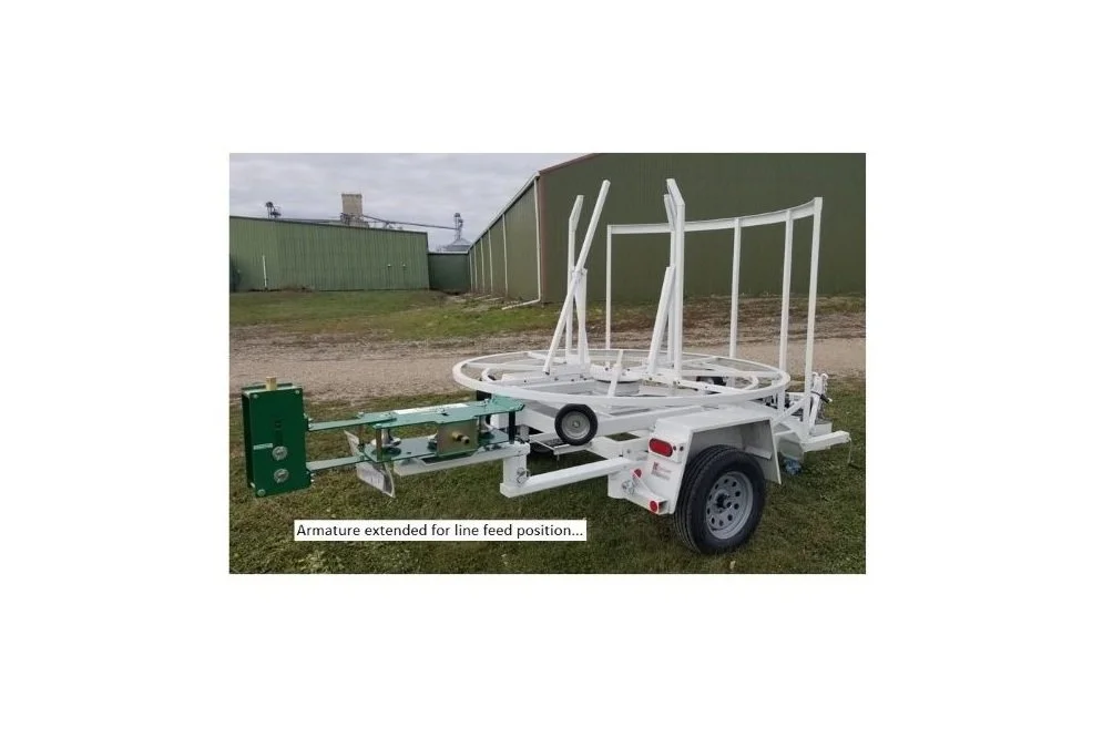 Trailer Mounted McElroy 2" Coil Pipe Line Tamer Armature in Line Feed Position. Right Side View.