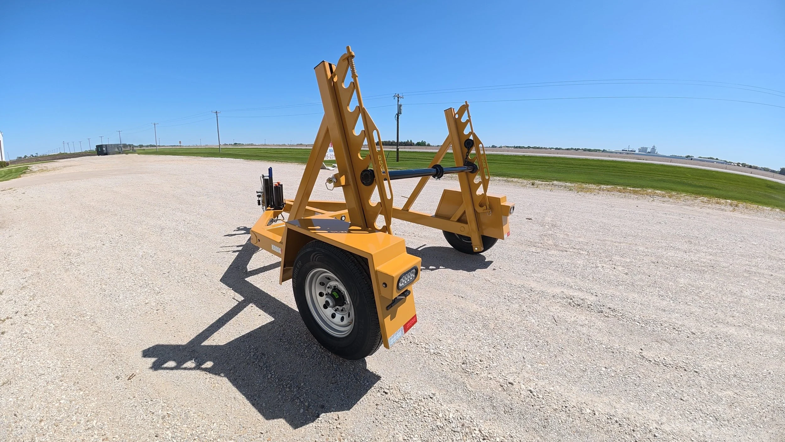 Single Reel Self Loading 7,000 lb. Axle Rated Trailer. From small fiber spools to large-diameter HDPE, PVC conduit, innerduct, and heavy electrical cable. Left rear corner view.