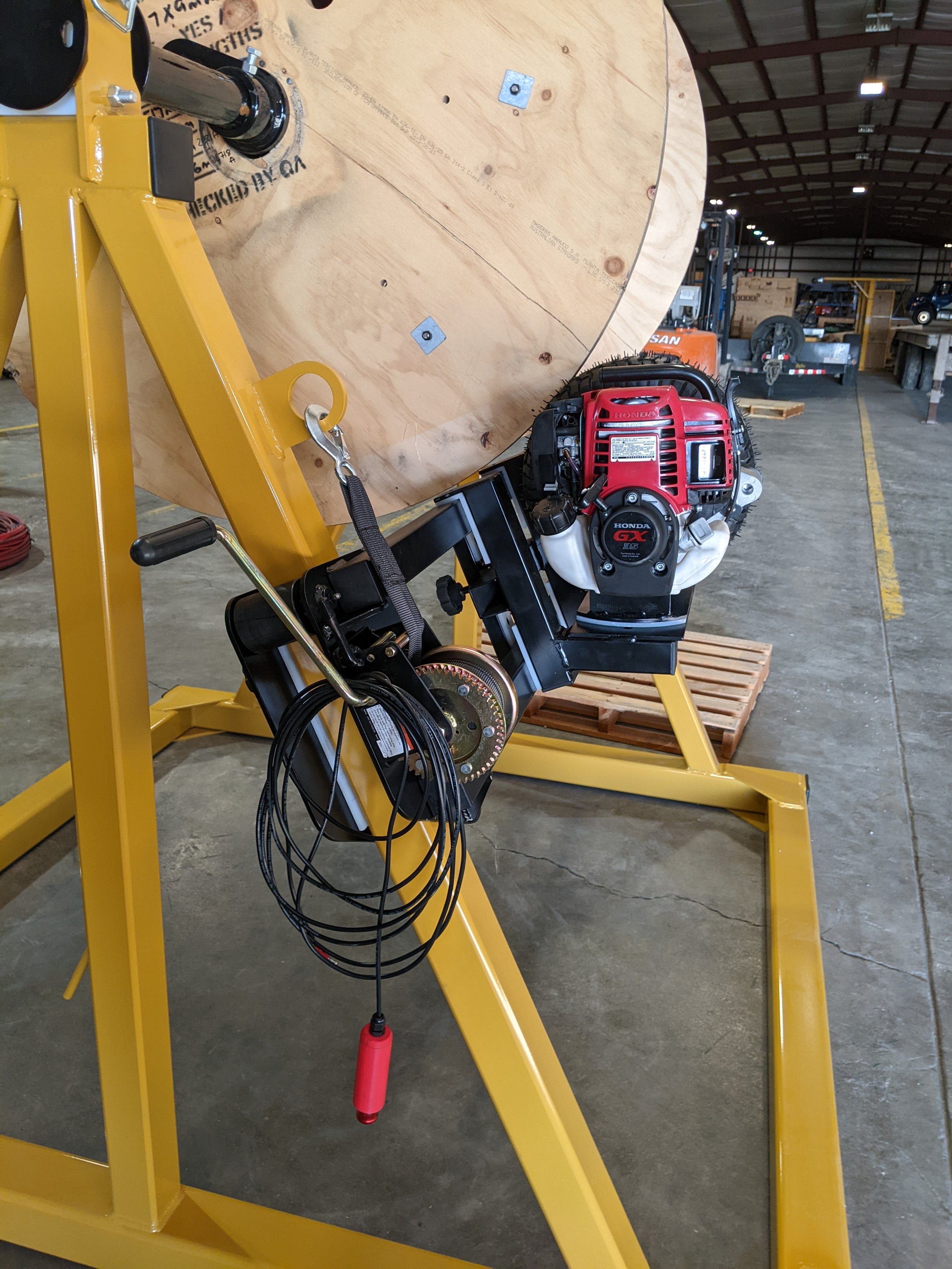 Profile view of reel stand gas powered rewind engaged.