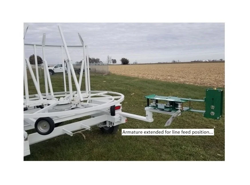Trailer Mounted McElroy 2" Coil Pipe Line Tamer Armature in Line Feed Position. Left Side View.