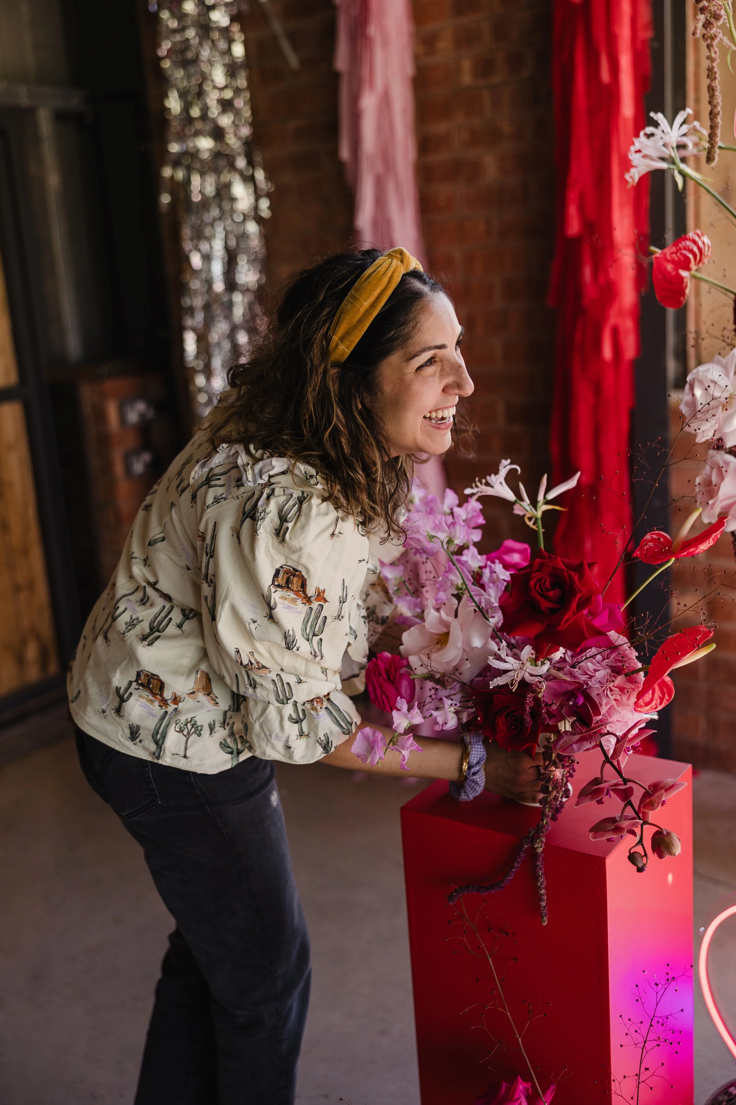 Amelia moving and setting up flower and smiling
