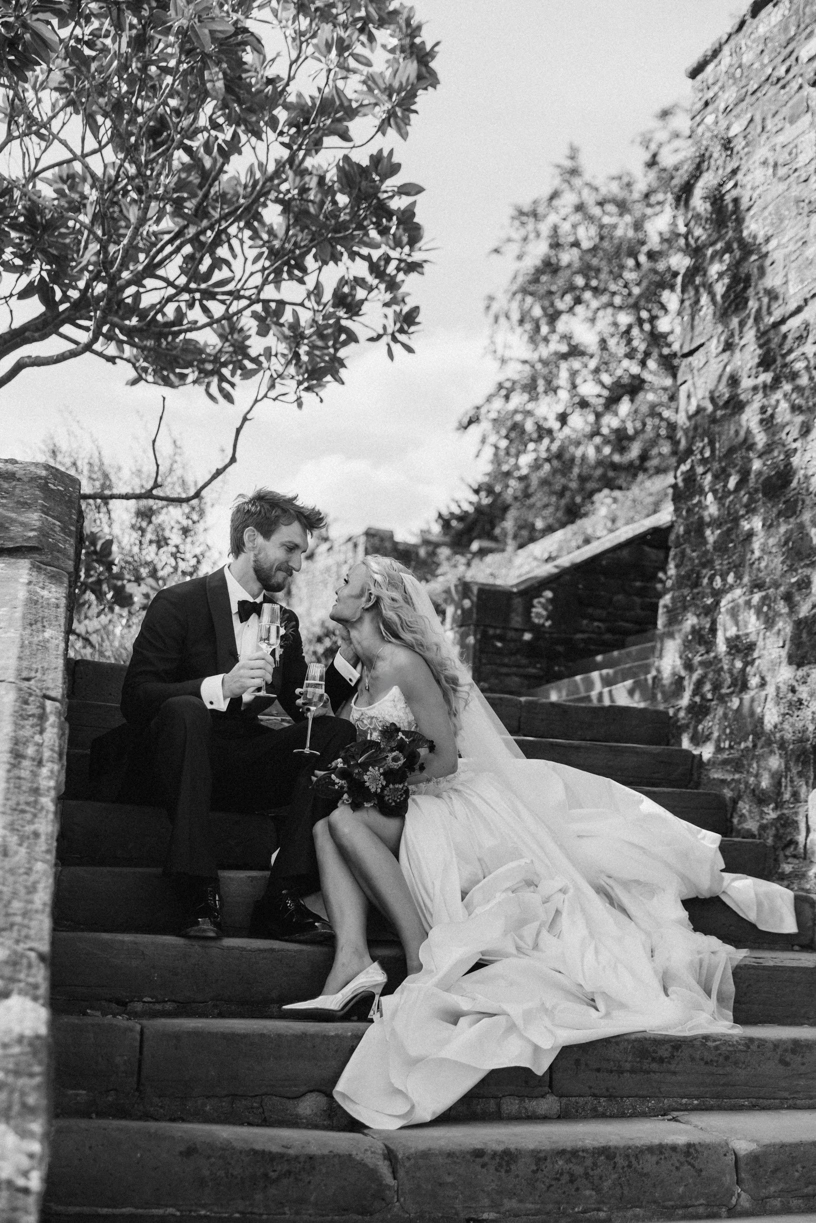 couple sitting on the castle stairs after the ceremony