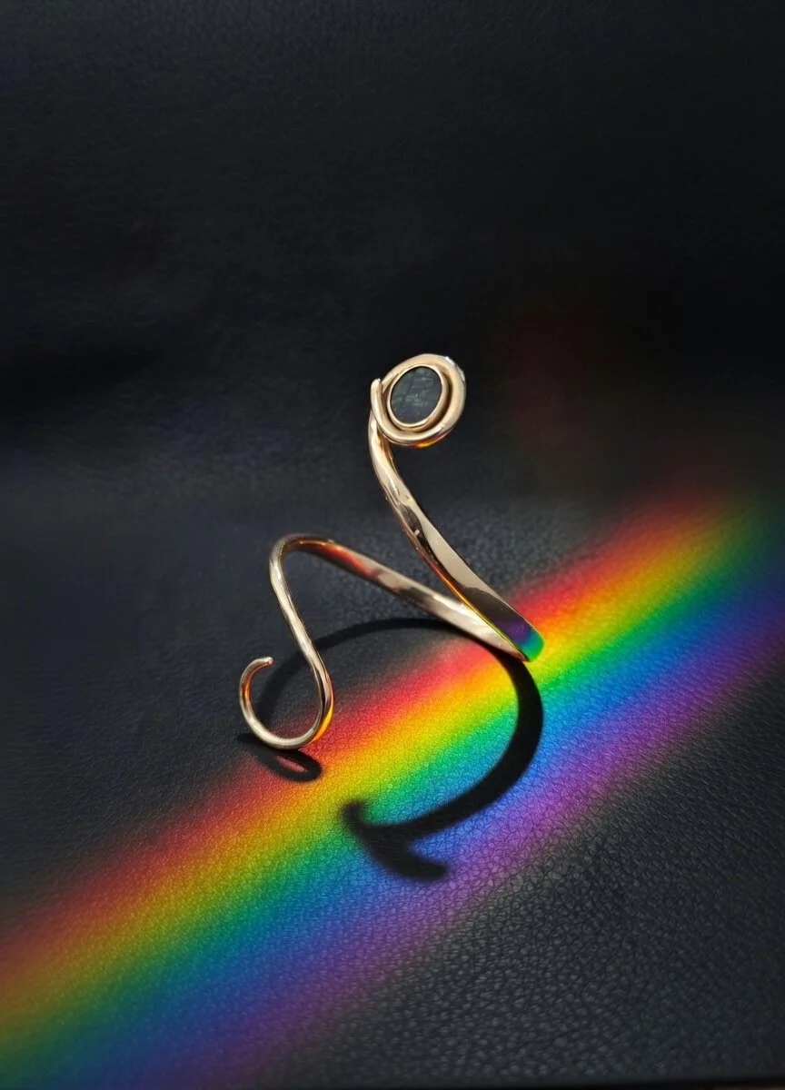 A gold open bracelet