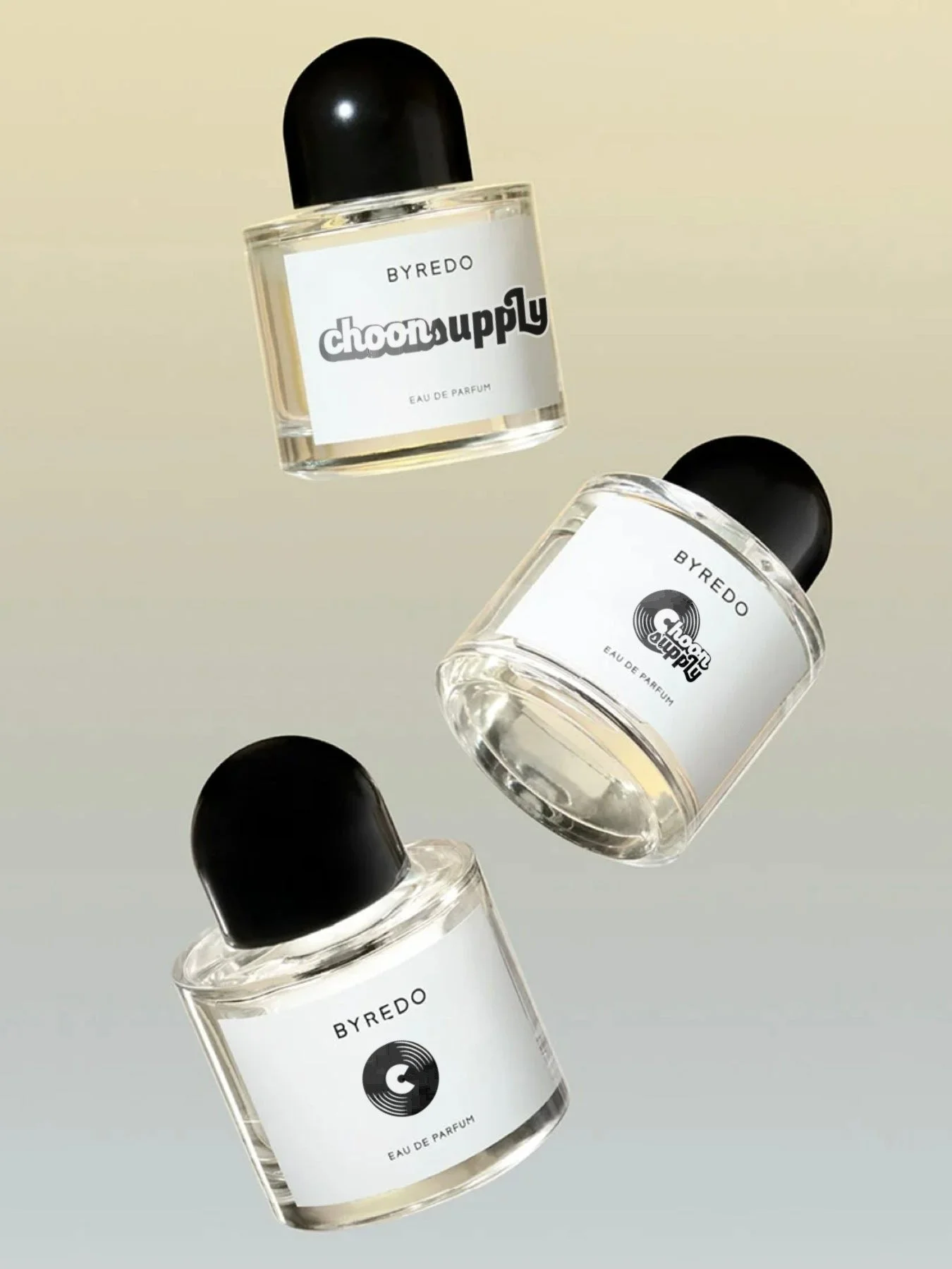 Three bottles of BYREDO Eau de Parfum floating against a light gradient background, with the middle bottle upside down and the others tilted.