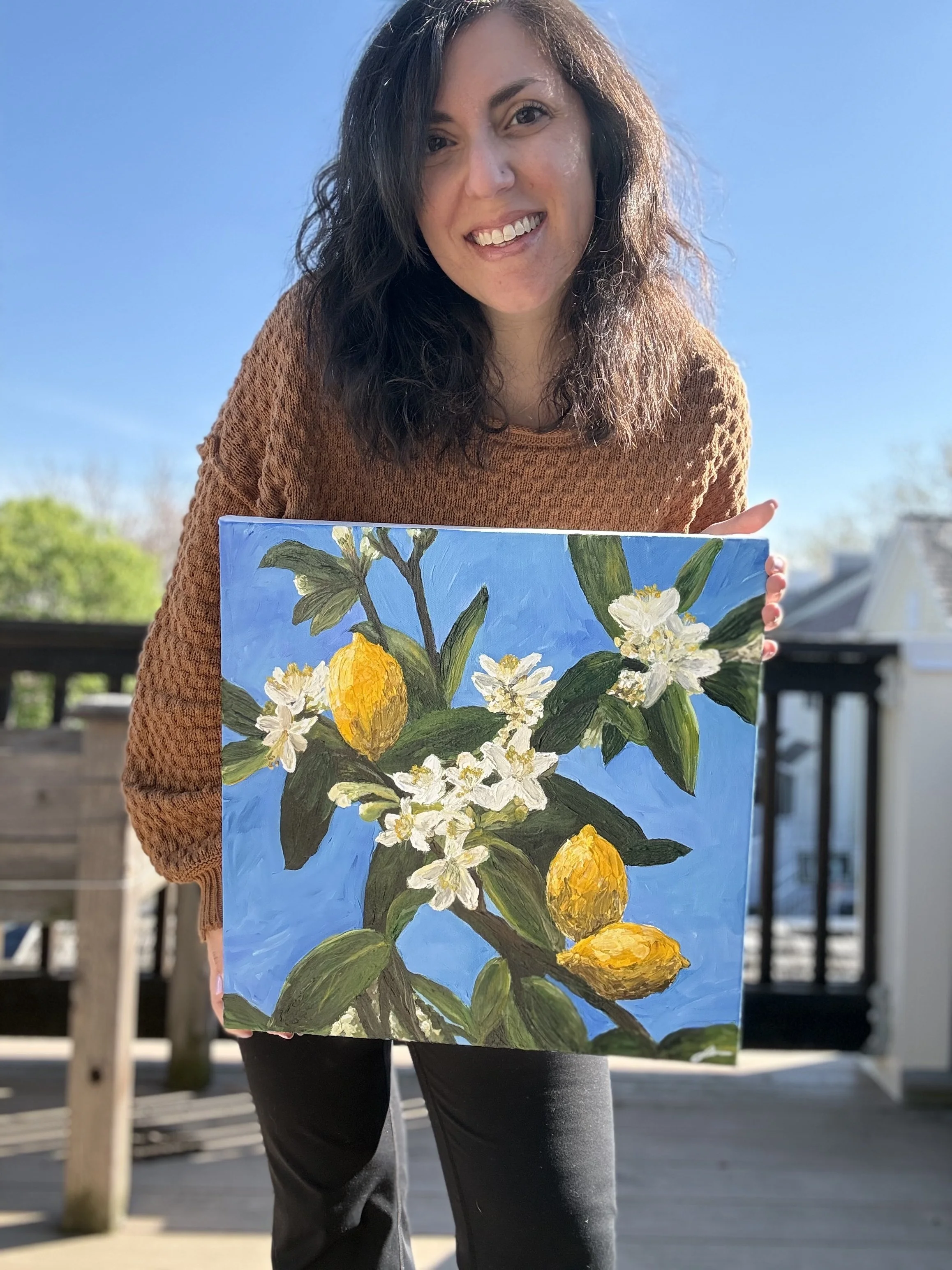 Maryland artist Sahar Boussard holding a custom commission painting