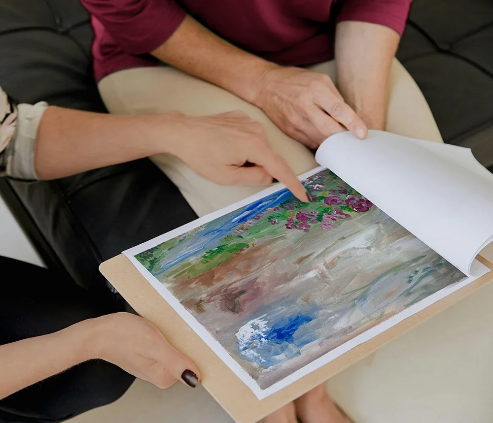 Artist and client review a sketch for a custom abstract art commission