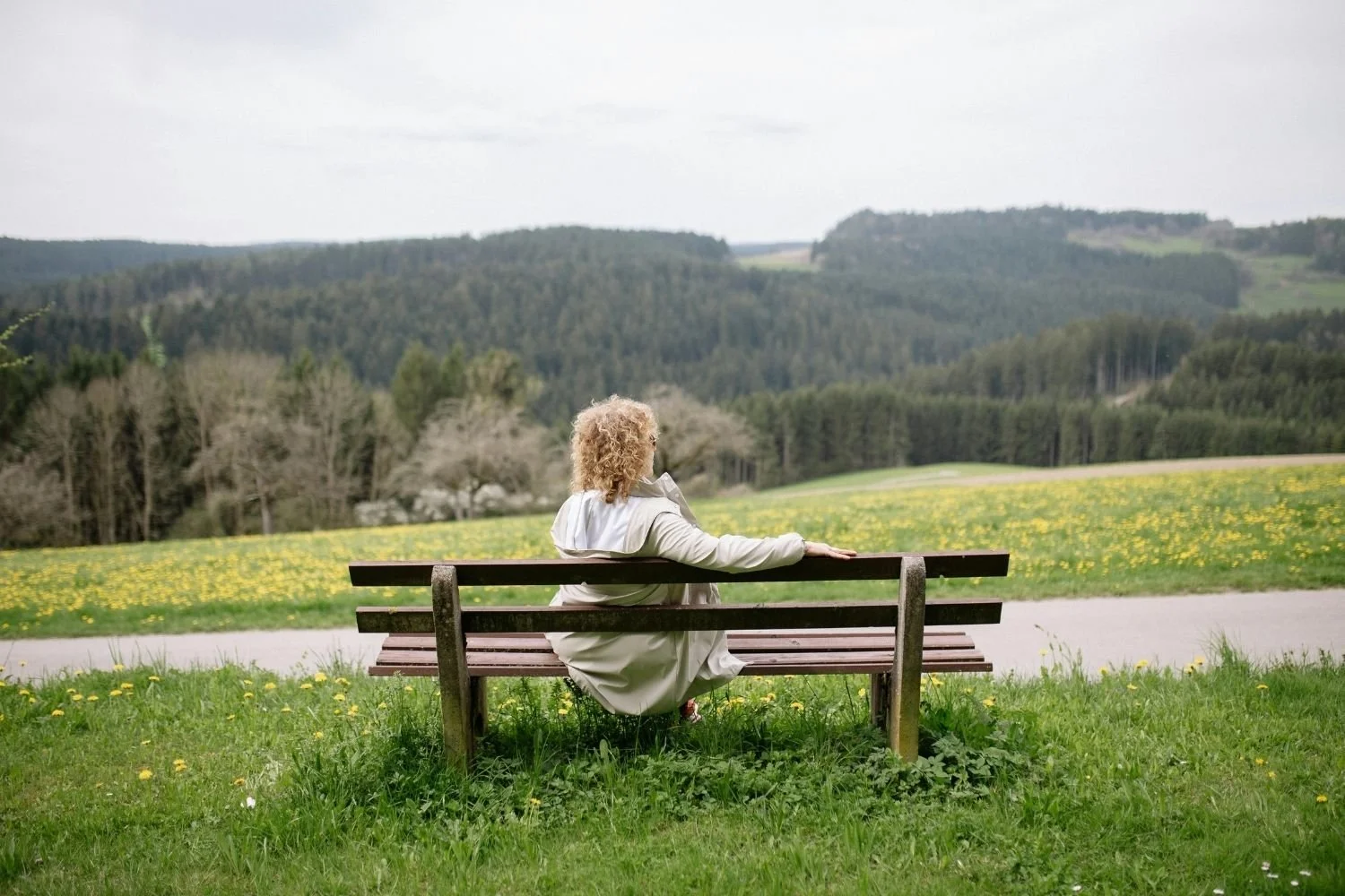 Woman Sitting on Bench Representing Why People Pleasers Become Resentful
